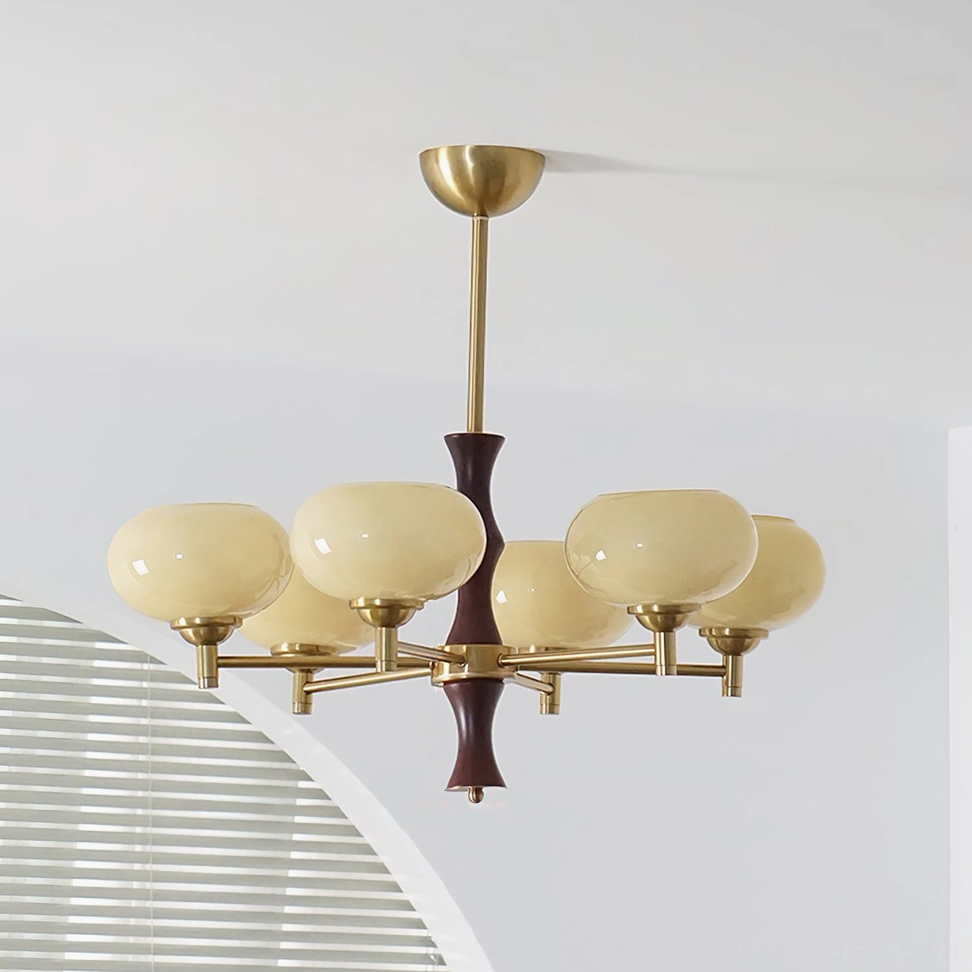 6-head mid-century chandelier featuring gradient amber-brown glass shades, brass arms, and dark wood stem in minimalist home interior