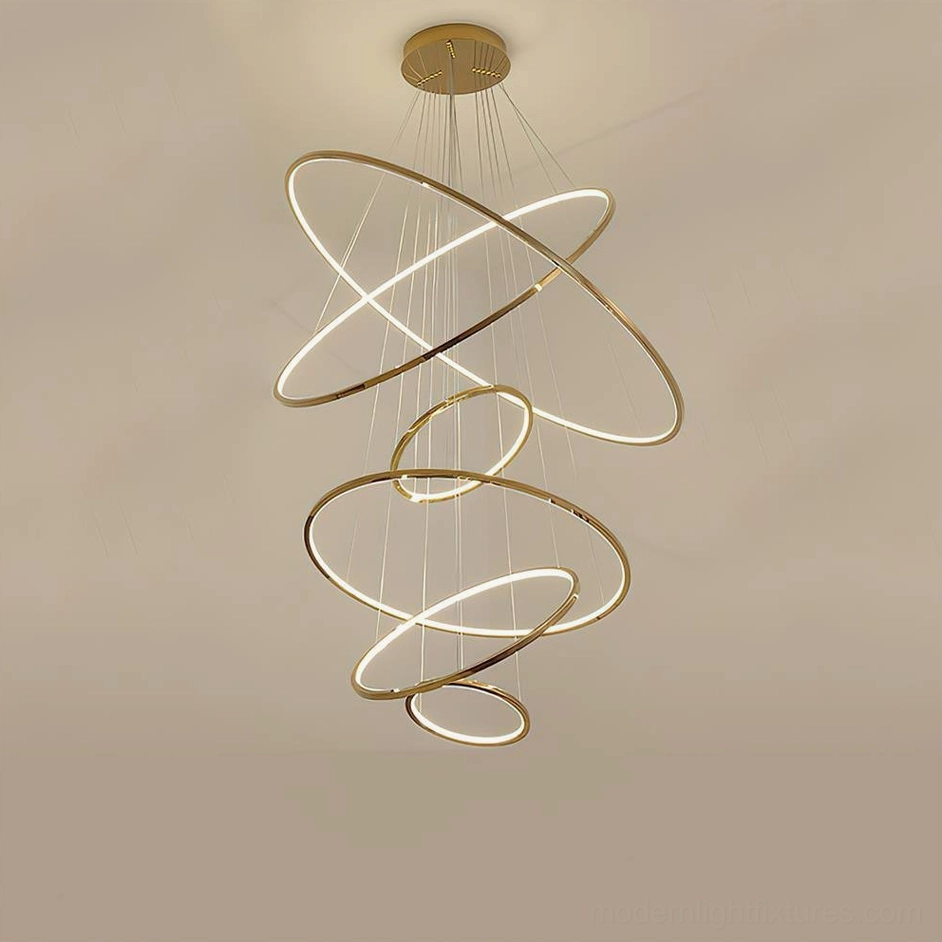 Large 6-ring gold ring chandelier serving as architectural focal point in high-ceiling modern interior