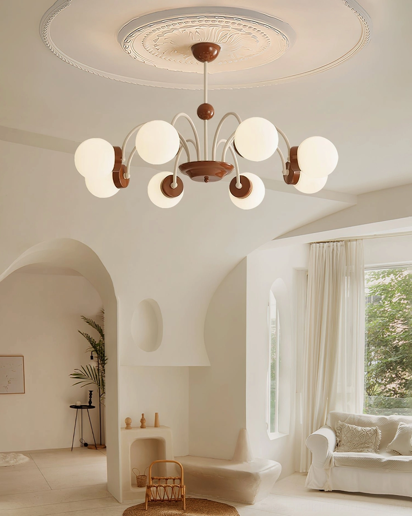 8-head modern globe chandelier installed in minimalist living room with neutral warm tones and architectural archway