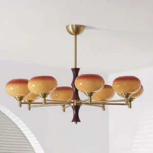 8-head vintage glass chandelier installed in minimalist home interior with arched louvered window, showing warm gradient brown-orange shades and brass hardware