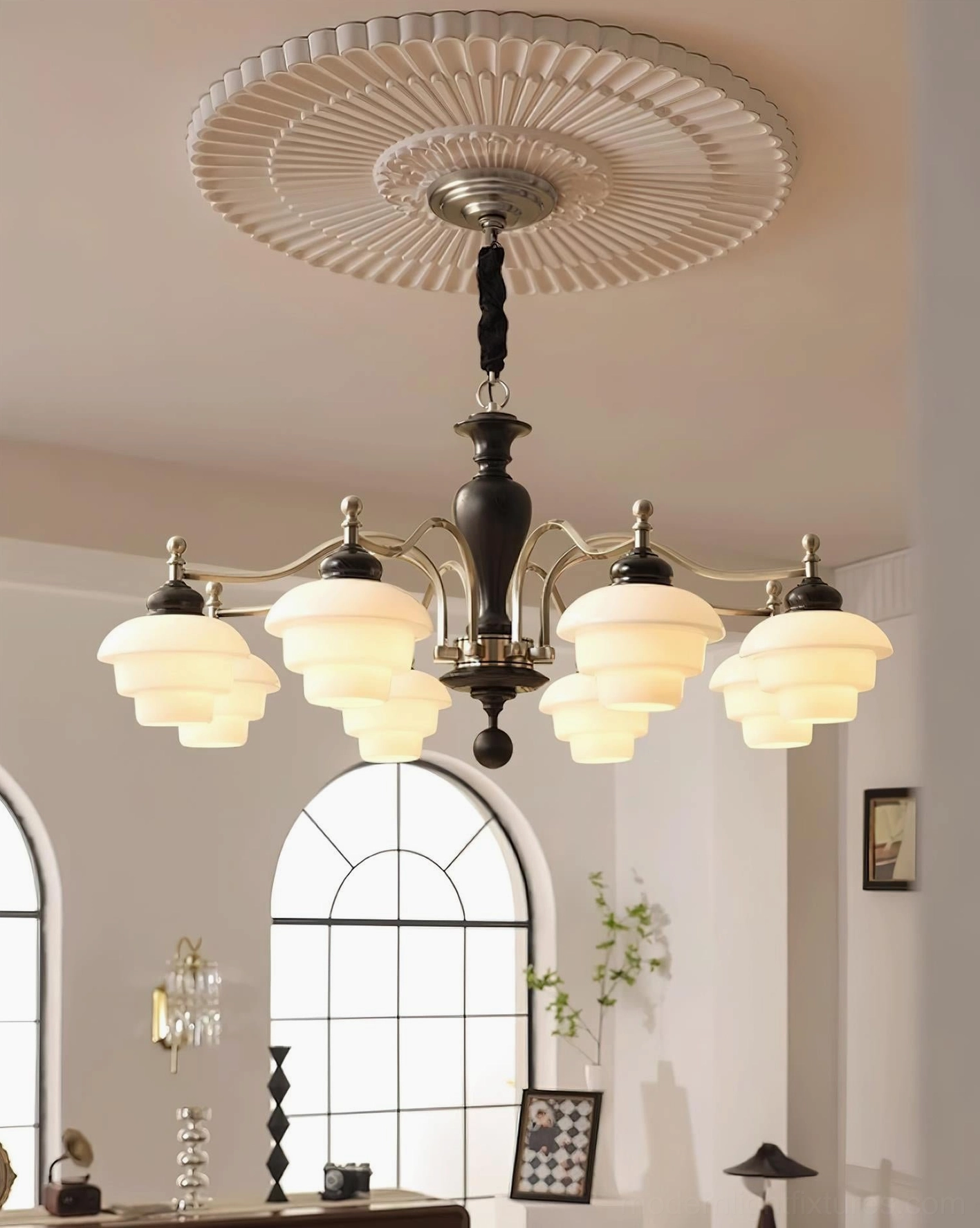 8-light vintage chandelier overhead view in vintage living room with arched windows - dark wood and black metal frame with brass accents and decorative ceiling medallion