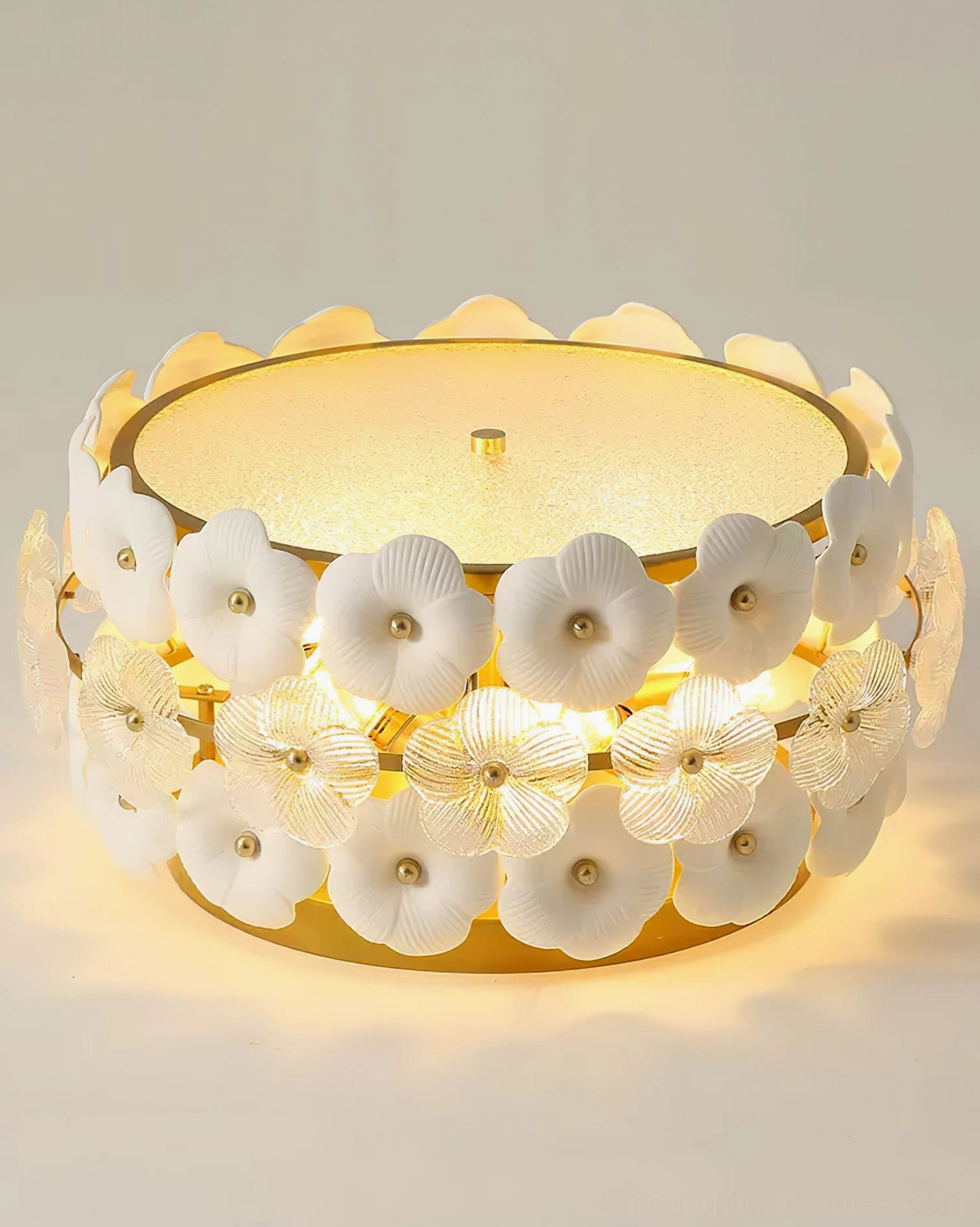 Three-quarter side view of Abella ceramic flowers ceiling light, displaying visible flower cluster and gold metal base rim
