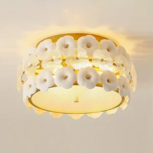 Abella ceramic flowers ceiling fixture with warm ambient lighting, showing flower-trimmed gold frame and soft light diffusion
