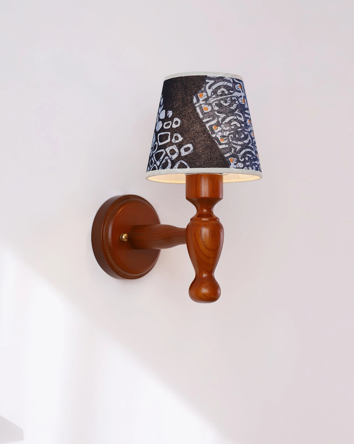 Contemporary wall sconce with abstract printed fabric shade, turned wood structure