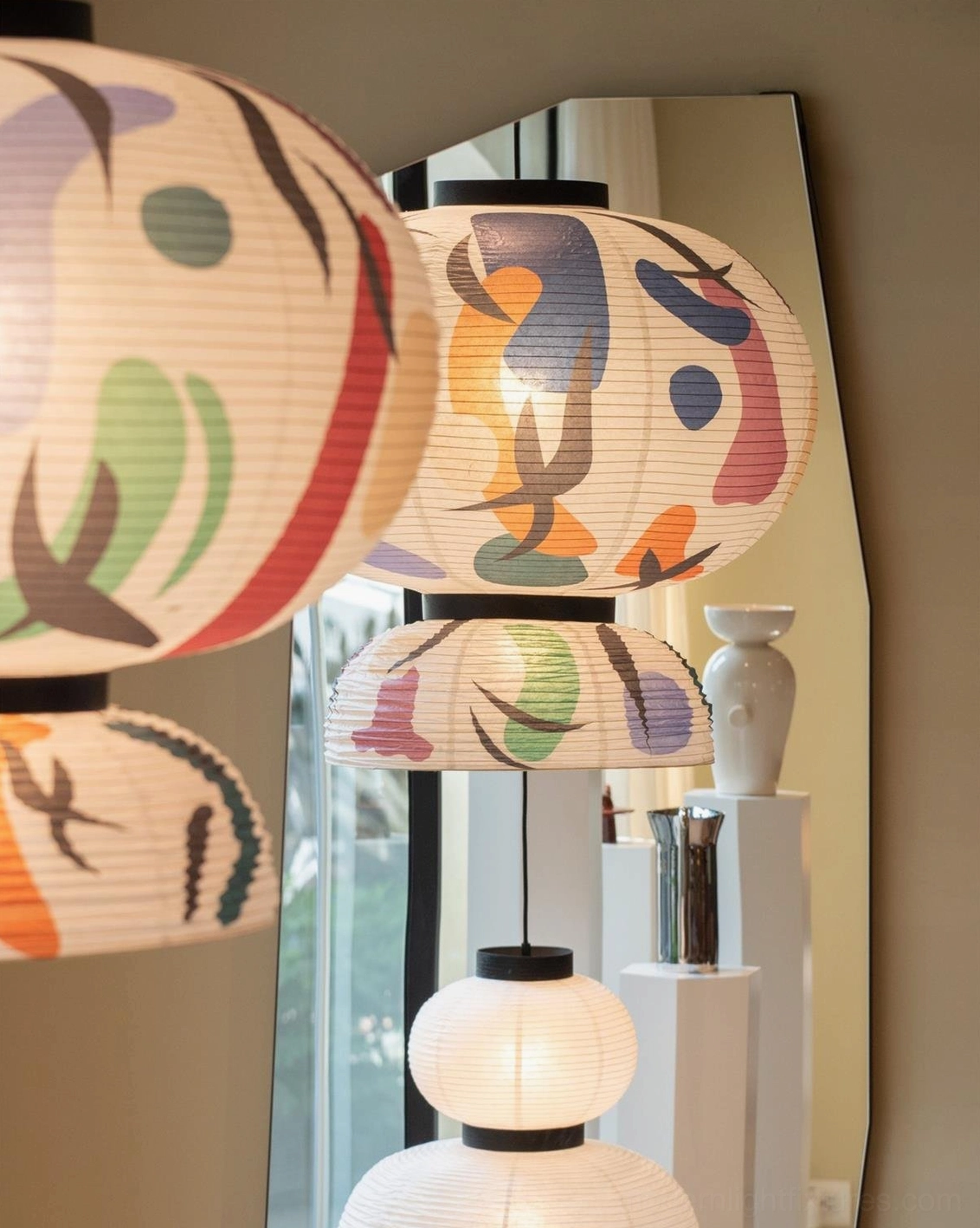 Abstract hand-painted pendant lamp showing warm diffused illumination and artistic expression in minimalist interior setting