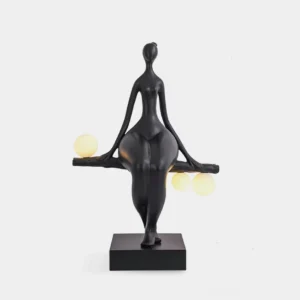 Abstract human sculpture floor lamp with three frosted glass orbs, matte black resin finish on square base, front studio view