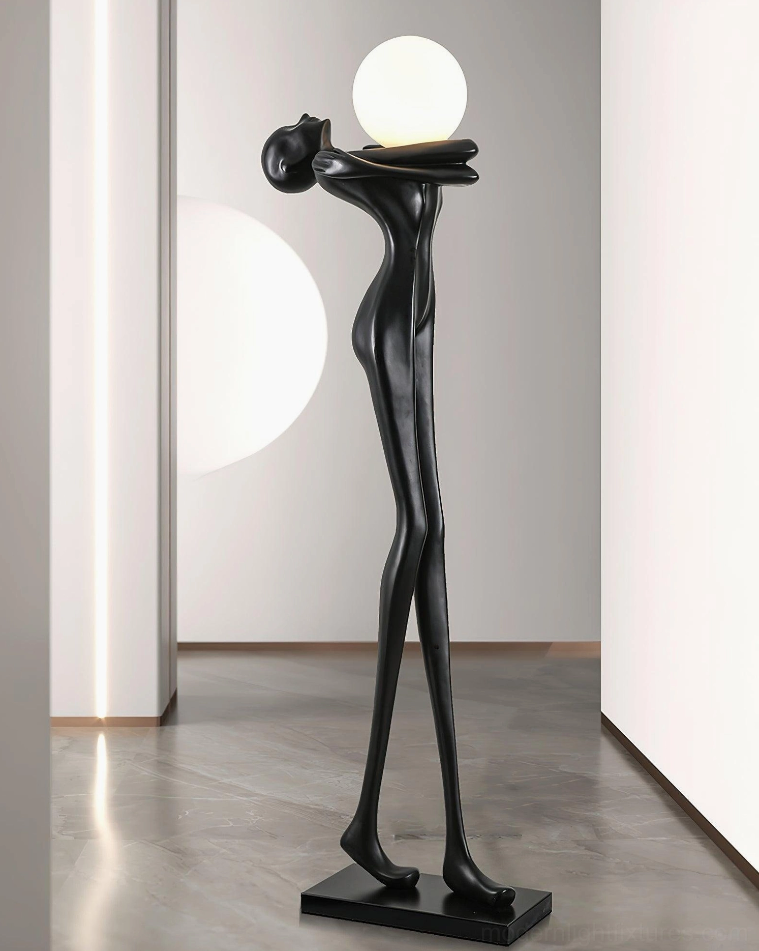 Minimalist black sculpture floor lamp in contemporary hallway, left side eye-level view, artistic human form design