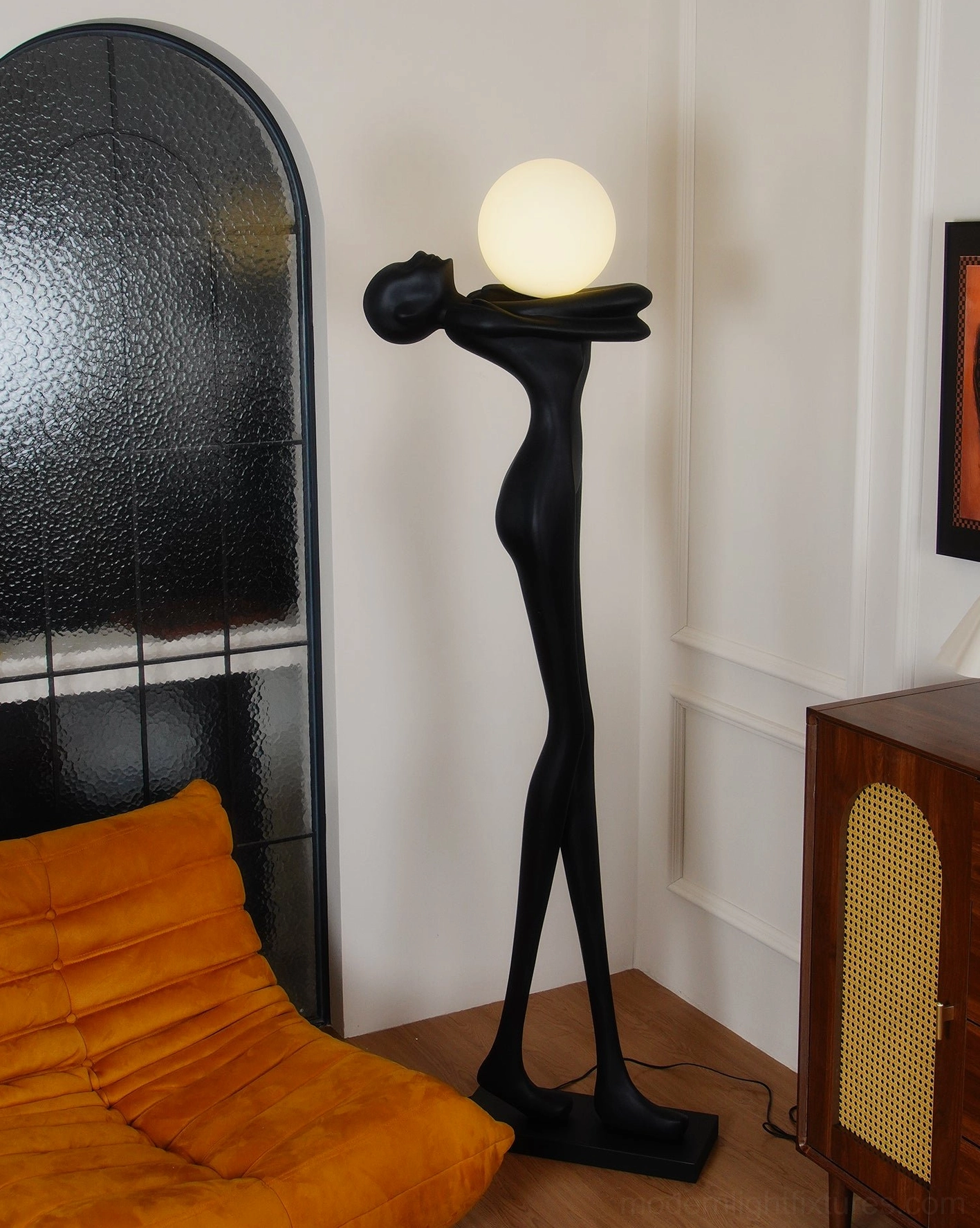 Contemporary human form floor lamp, bedroom environment, matte black resin body artistic silhouette