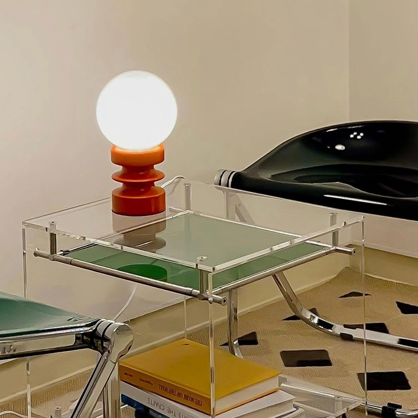 Wooden pleated base detail and glass sphere of contemporary table lamp fixture