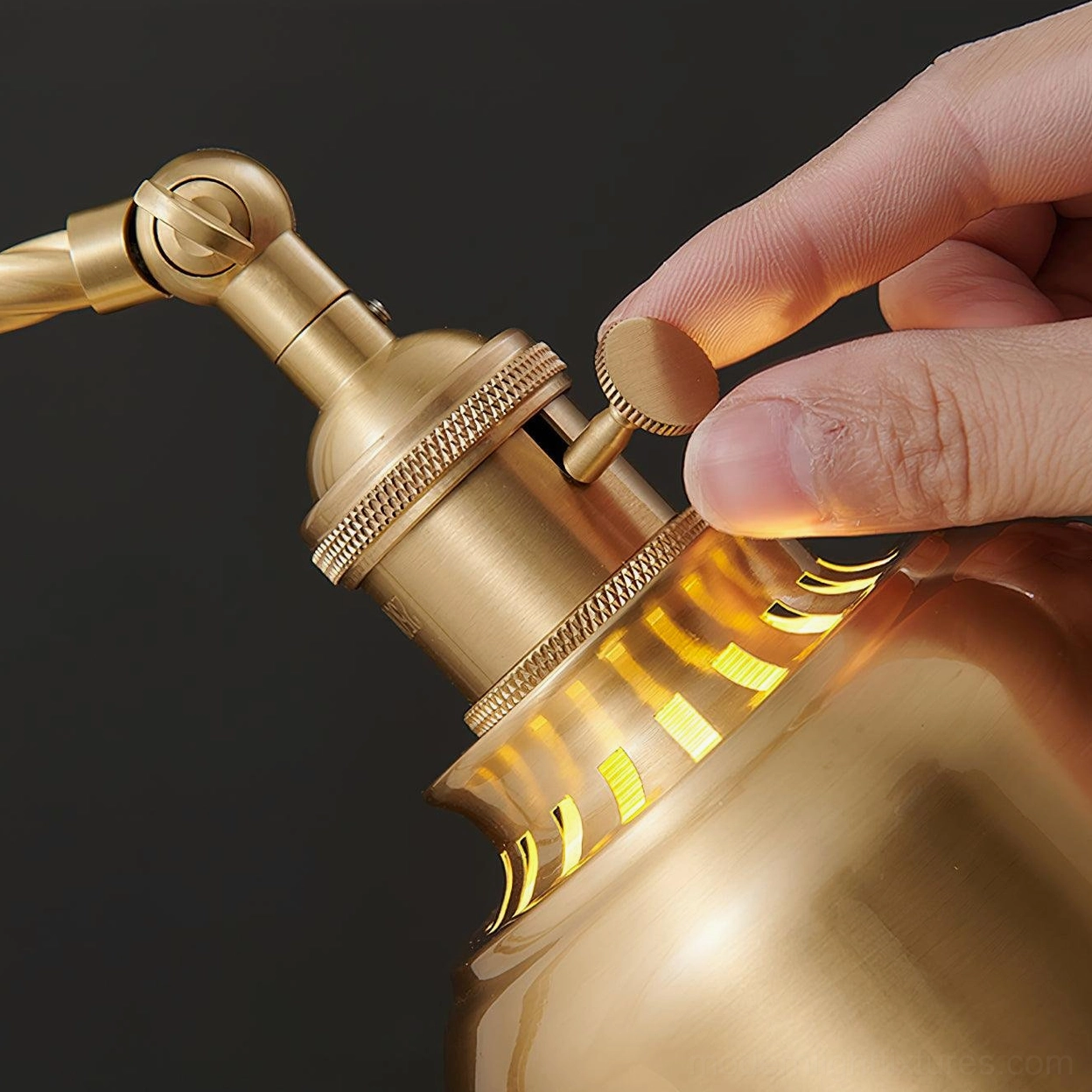 Brass industrial desk lamp with adjustable lamp head positioned on workspace desk surface