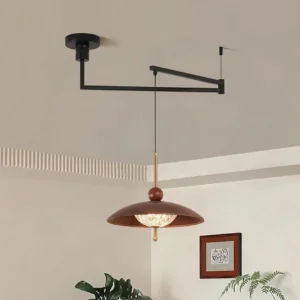 Modern swing arm pendant light over dining table in residential interior with warm ambient lighting