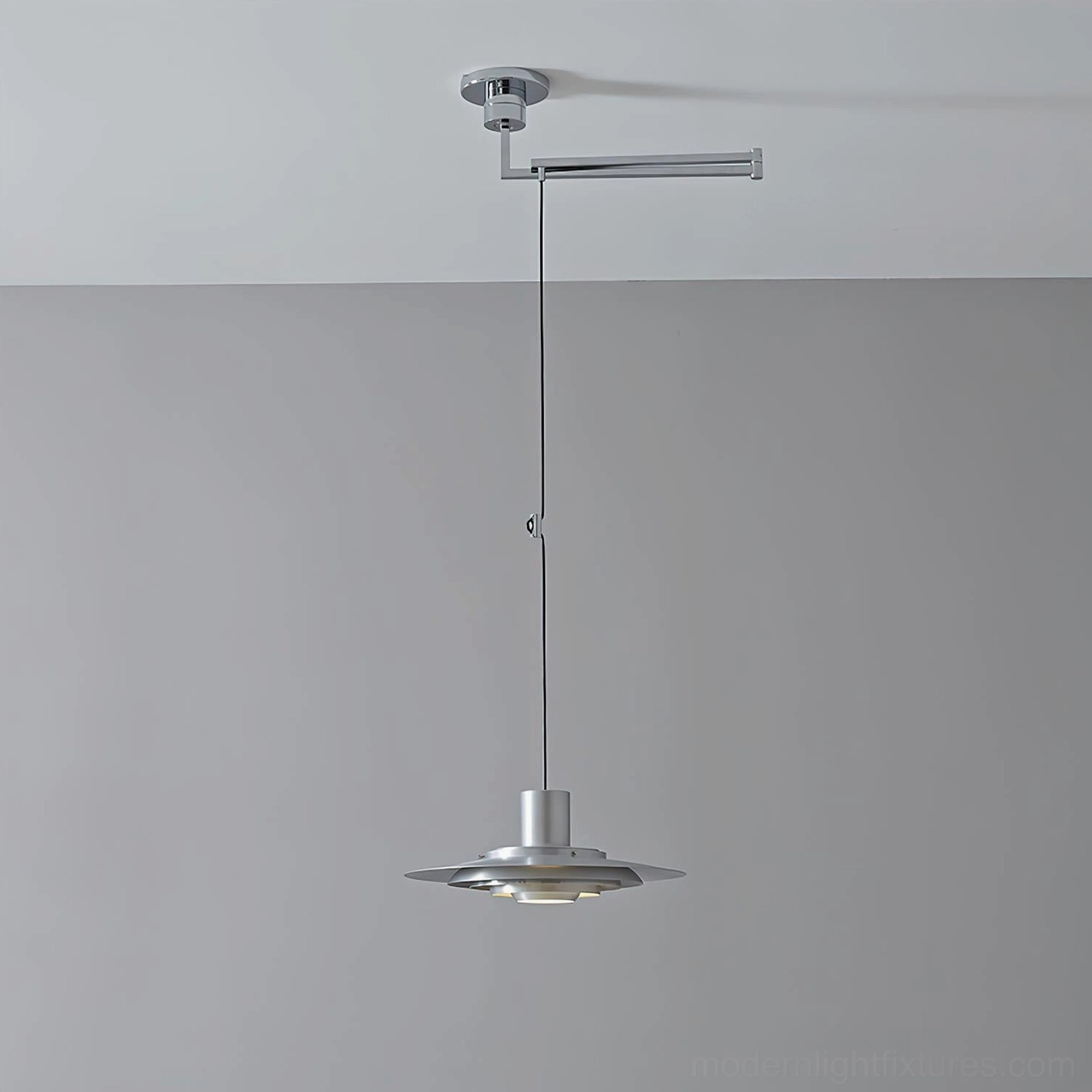 Adjustable swing arm pendant light front oblique view, minimalist metal construction with articulated mechanism, studio lighting
