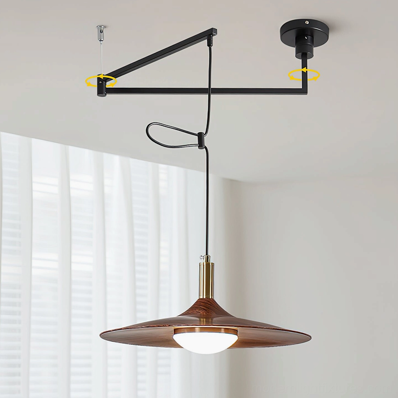 Adjustable pendant lamp from side angle showing rotatable metal arm and wooden disc shade against window blinds