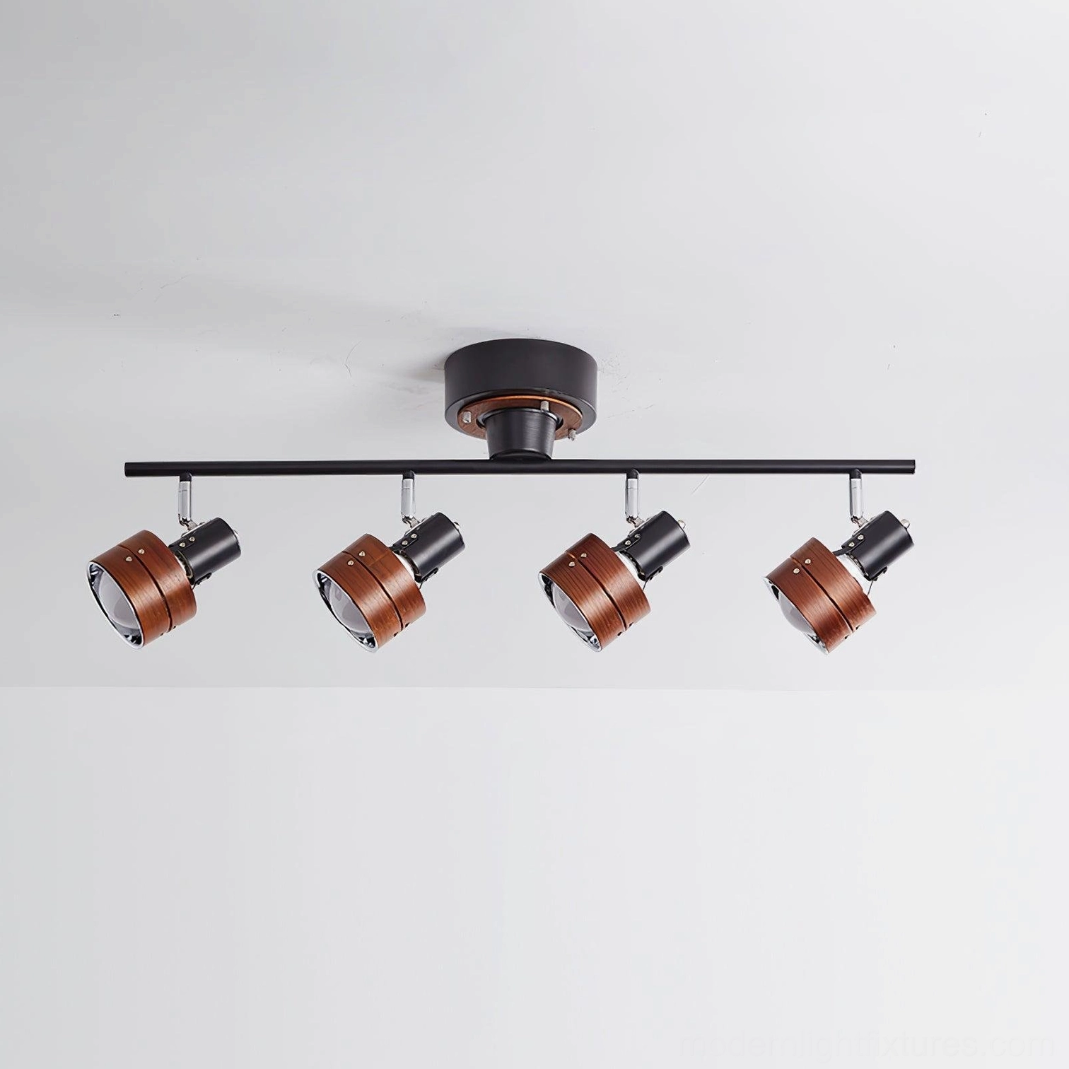 Four-head adjustable track lighting with black metal rod and dark brown wood-grain lamp housings display