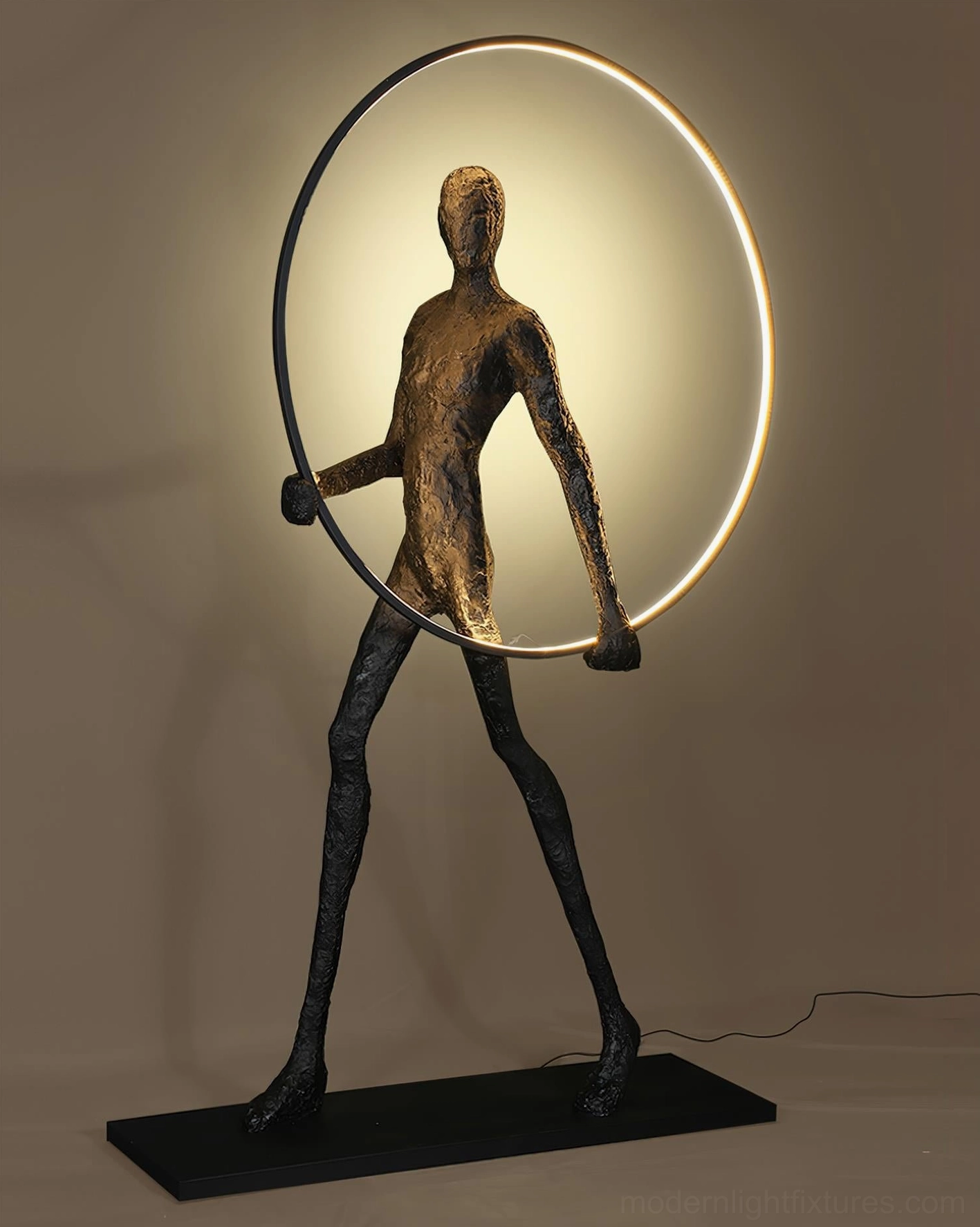 Geometric human sculpture floor lamp with warm glowing circular frame, modern living room ambient lighting statement