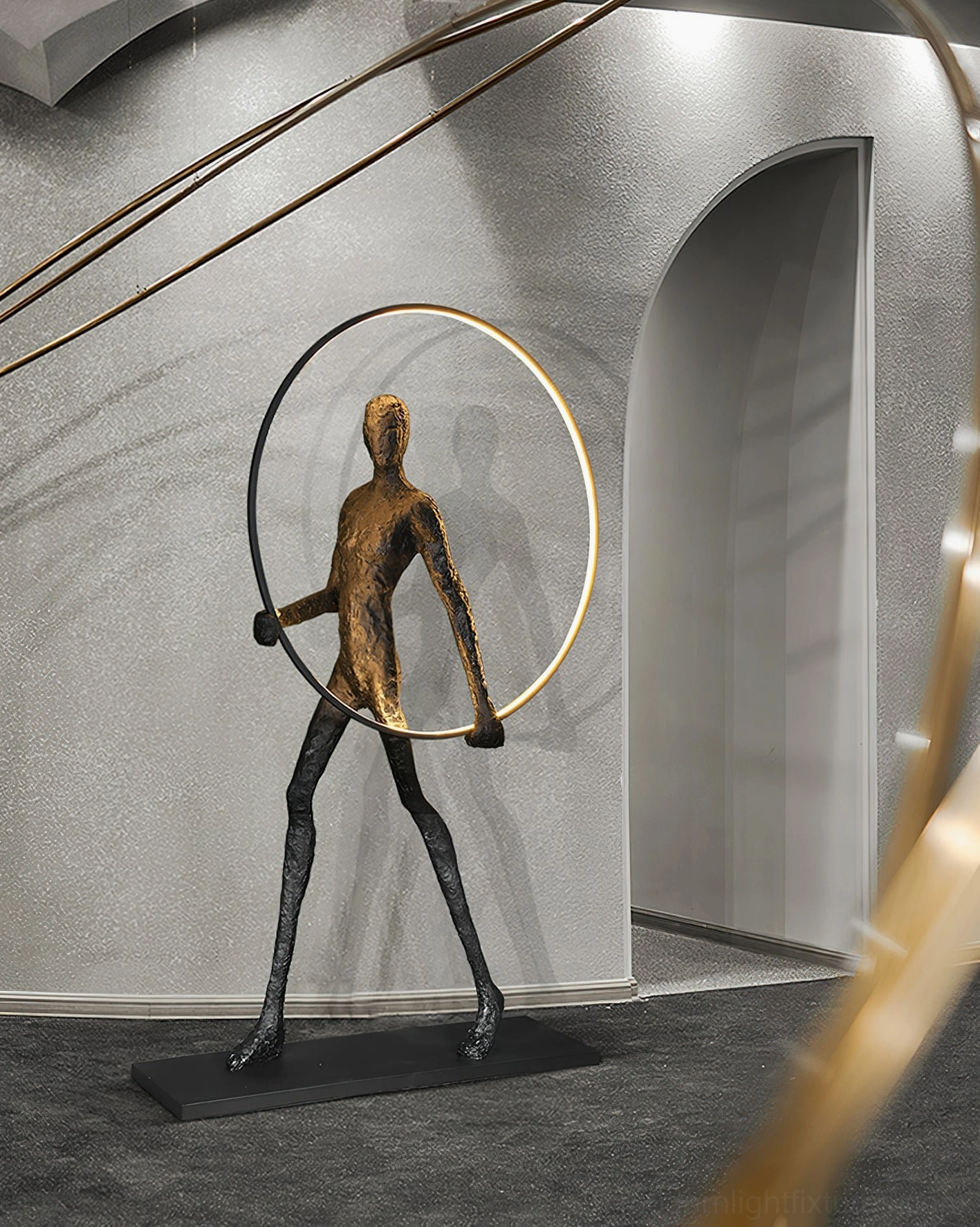 Modern geometric sculpture floor lamp with human figure, warm LED light display in minimalist home office environment