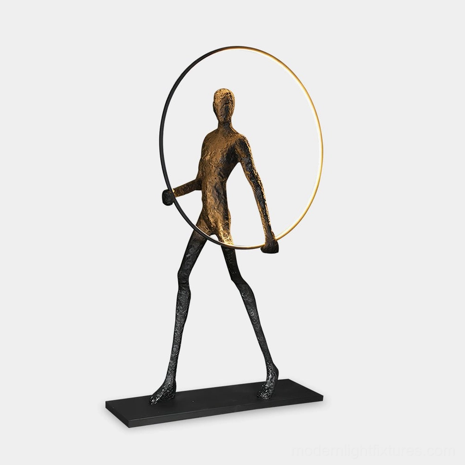 Aeon Sculpture Floor Lamp with bronze-toned human figure and golden LED light ring, frontal studio view on white background