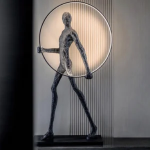 Contemporary human sculpture floor lamp with black textured figure and circular LED light, three-quarter angle view