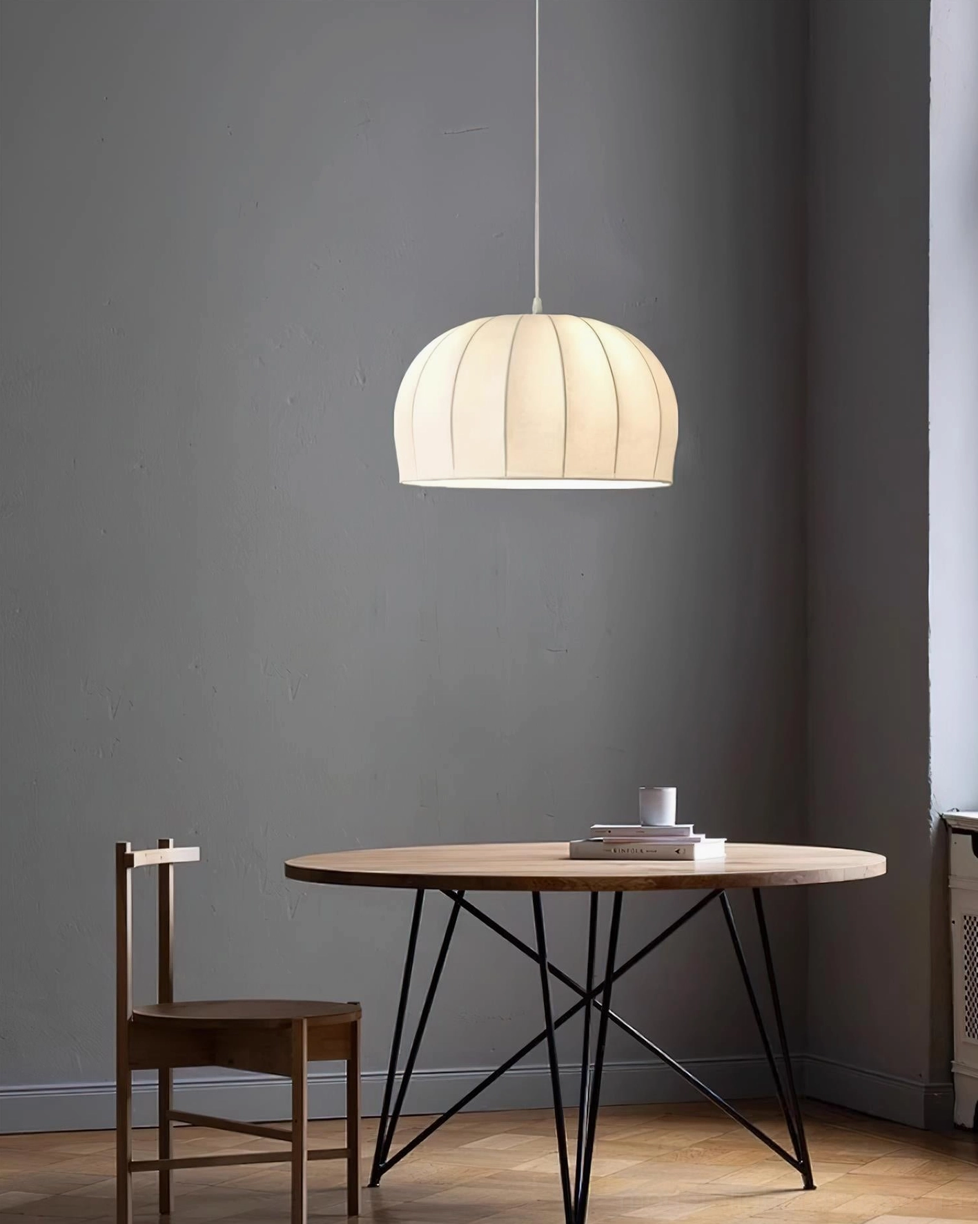 Small Aeron pendant lamp in compact apartment dining corner, off-white ribbed shade neutral walls