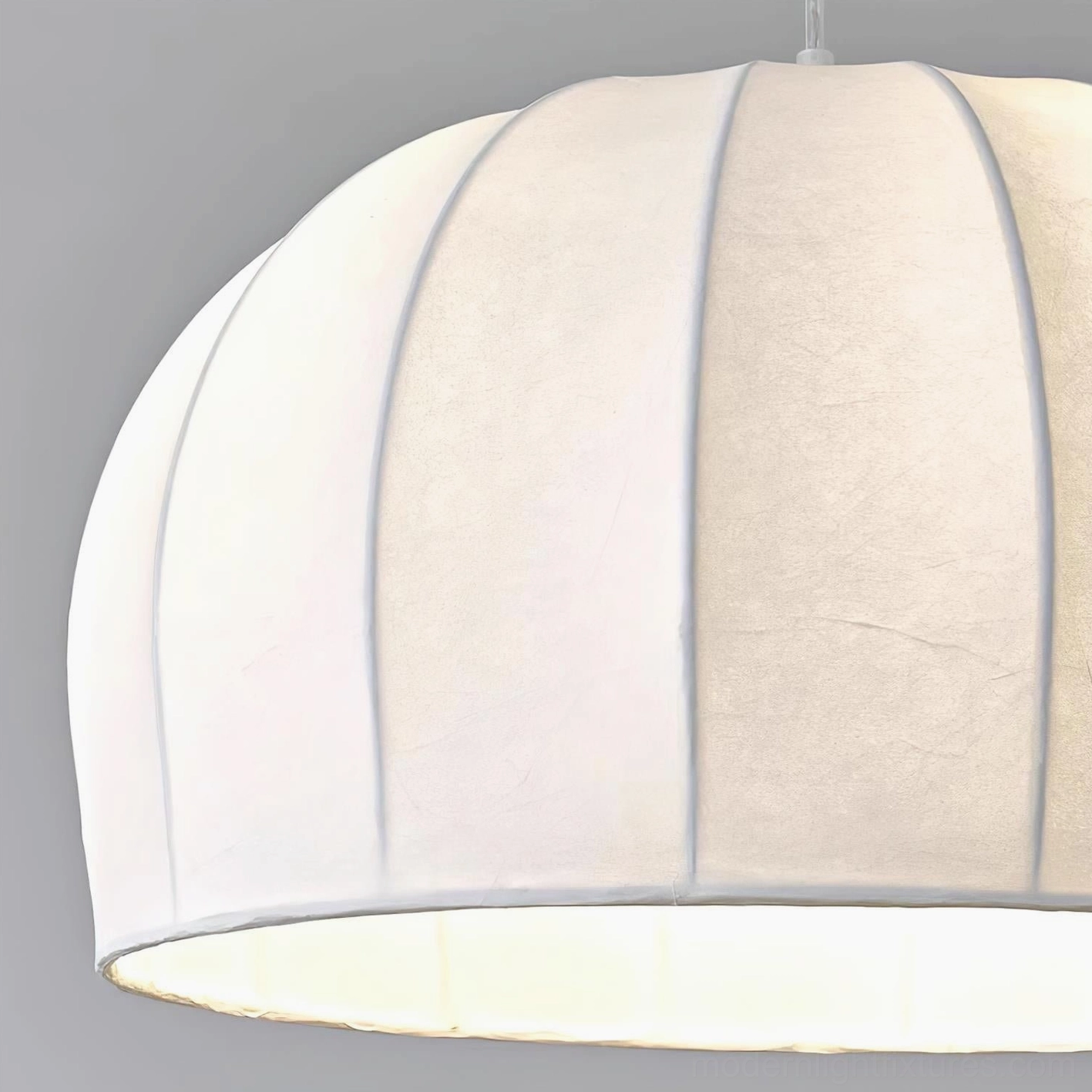 Pair of matching Aeron white ribbed pendant lights in large modern dining room with wabi-sabi interior