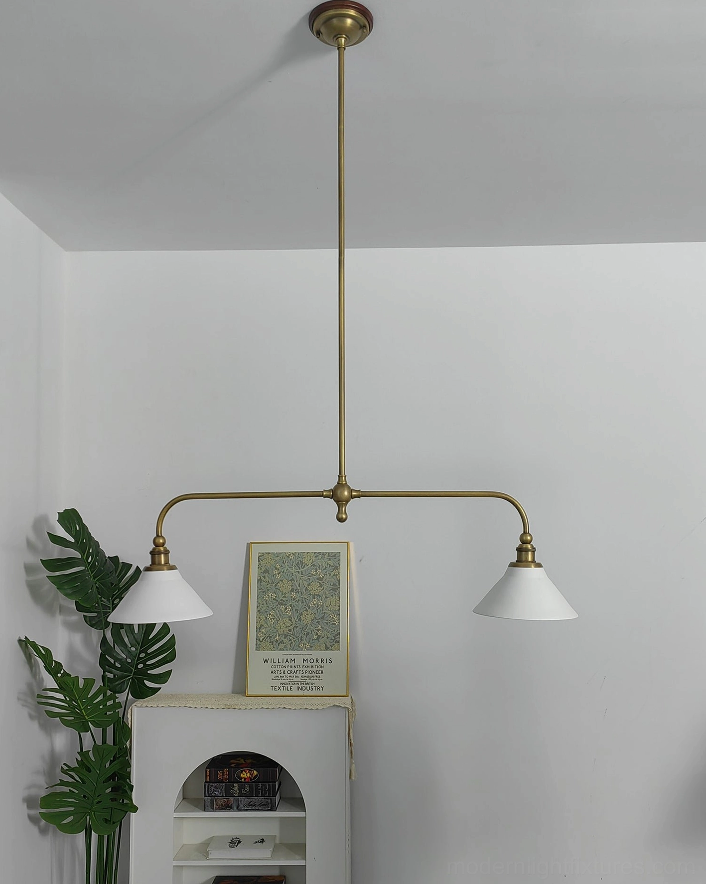 Linear pendant chandelier with aged brass finish and white ceramic conical shades, elegant minimalist product presentation