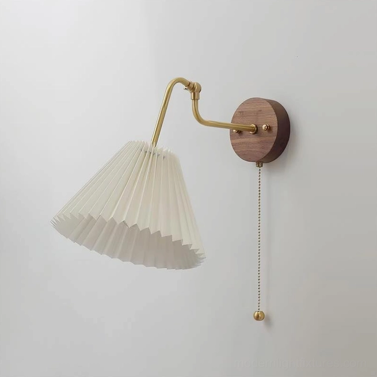 Aine pleated wall lamp direct front view, off-white pleated shade with pull chain mechanism and brass hardware