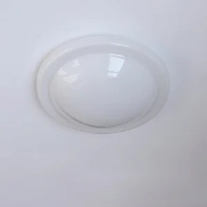 Top-down view of Aire flush ceiling light featuring clear acrylic smooth dome and thin metallic rim in studio lighting