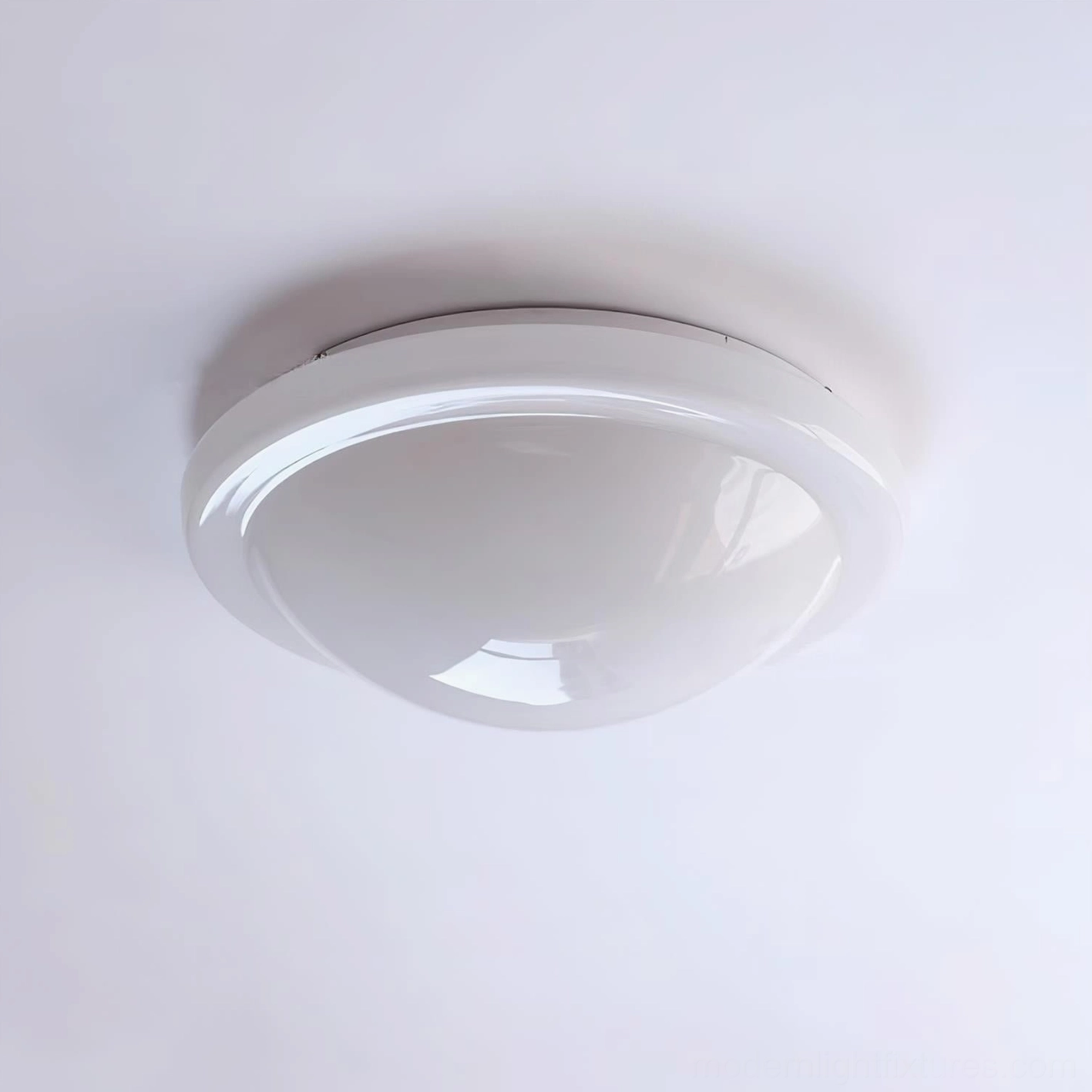 Aire modern ceiling light fixture detail showing metallic trim and cream-white glass dome texture in close-up view