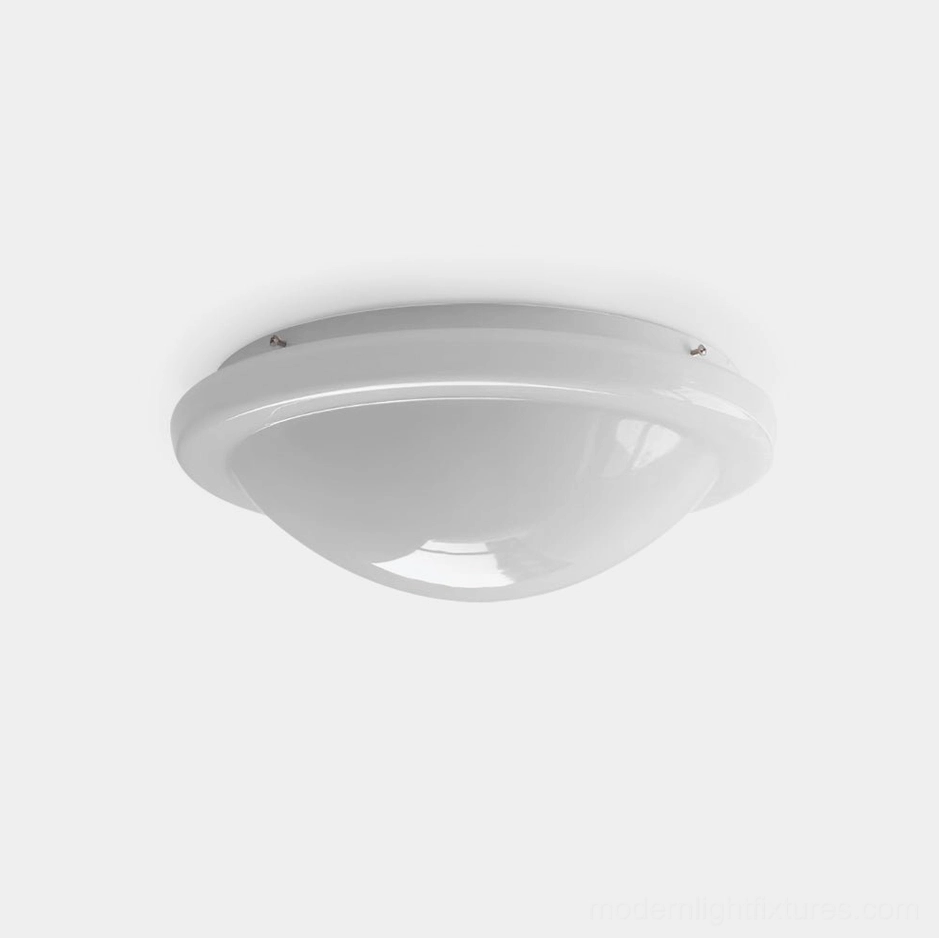 Aire white flush mount ceiling light fixture with slim metallic trim and cream-colored glass dome, side oblique view showing minimalist modern design
