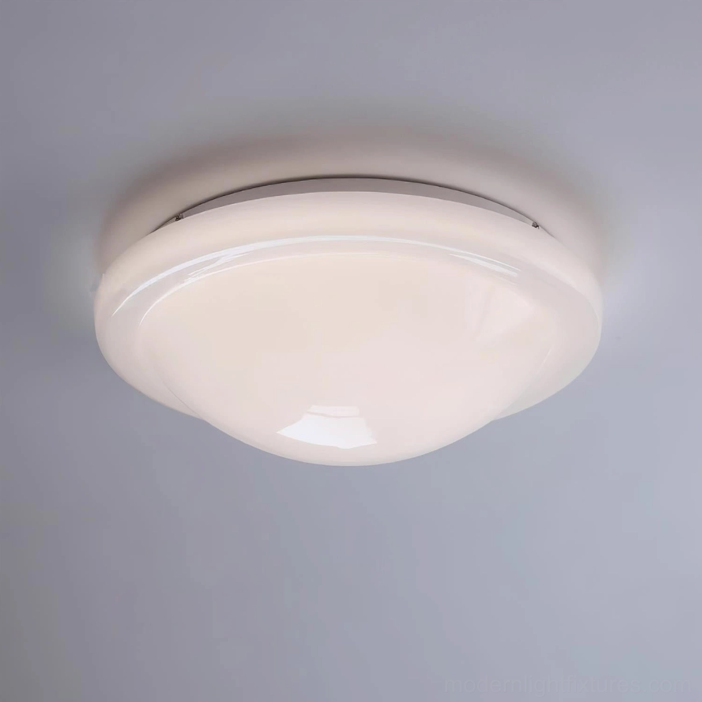 Aire 40cm flush mount ceiling light showing complete fixture design with integrated LED technology and metal-glass construction