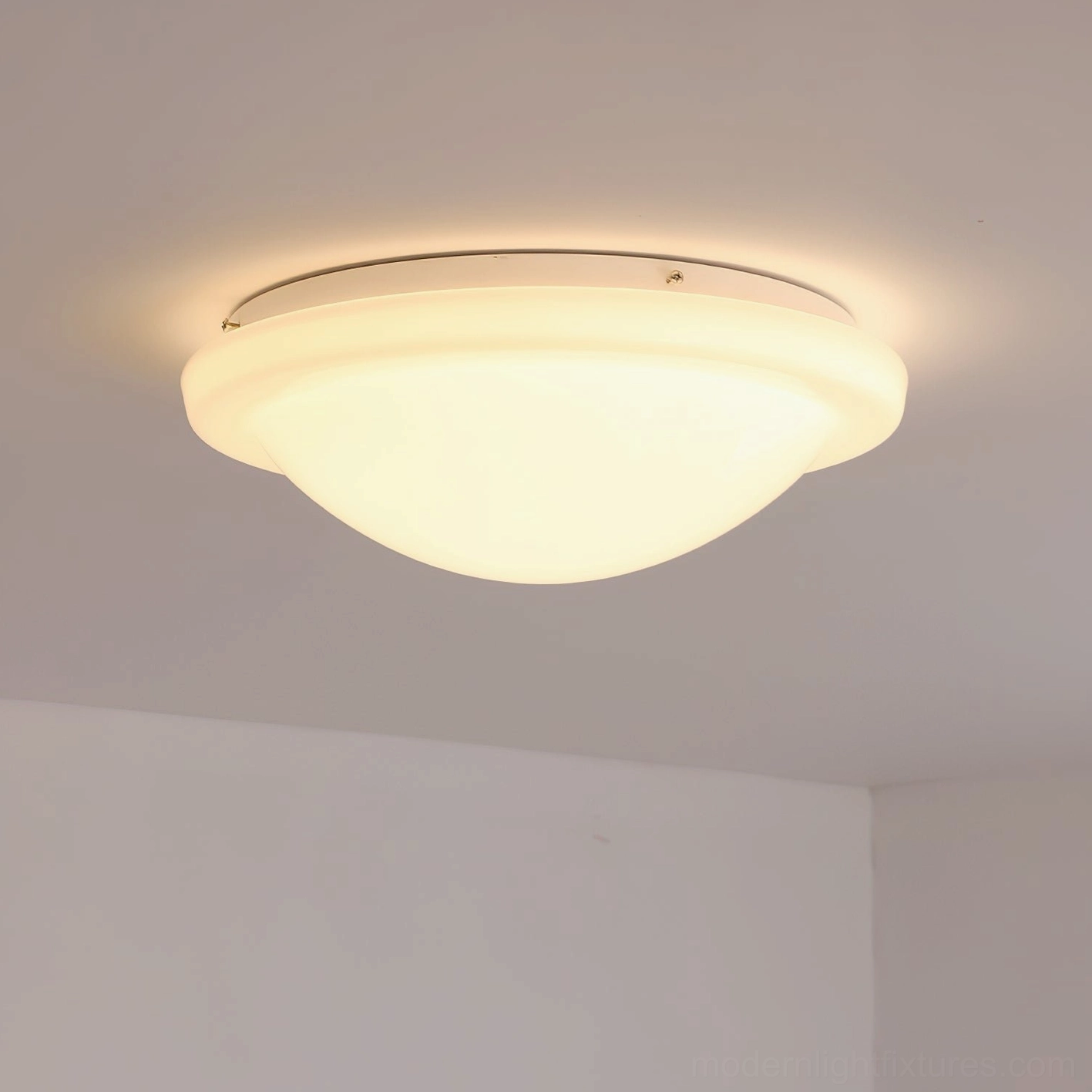 Aire warm white LED ceiling light illuminated in residential interior corner, showing ambient warm glow and light diffusion quality