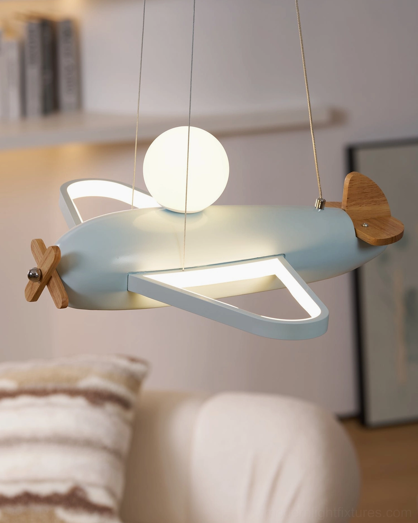 Airplane pendant fixture showing metal and wood material combination in close detail overhead view