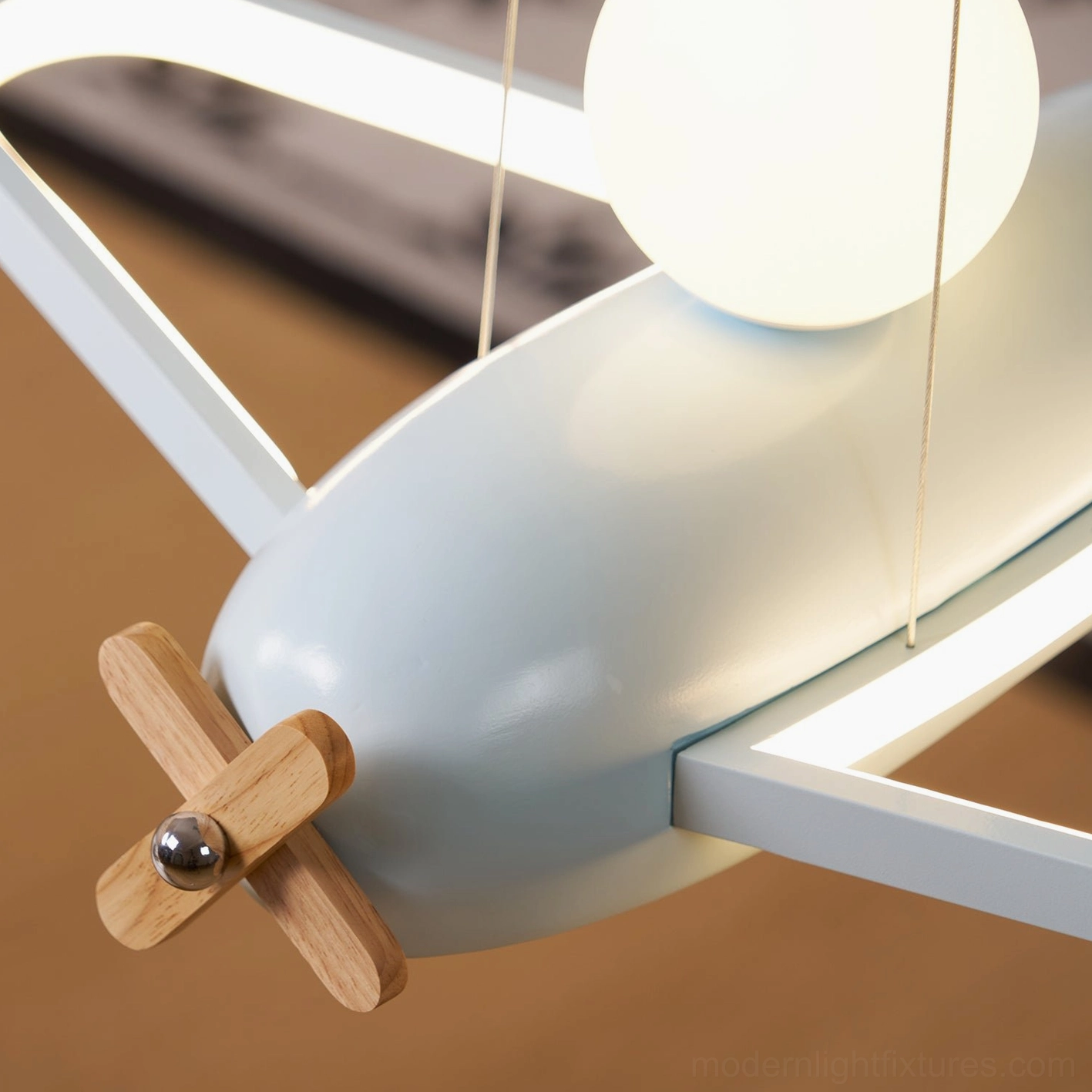 Airplane pendant light showing integrated LED circular glow pattern creating soft even illumination below fixture