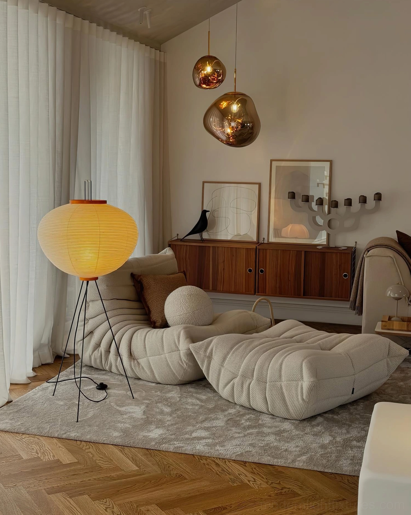 Akari 10A floor lamp illuminated in living room with bean bag sofa and wooden cabinet, yellow pleated shade