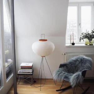 Akari 10A floor lamp in Nordic living room corner with fuzzy chair and minimal decor, unlit white shade