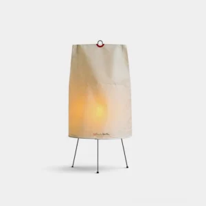 Akari 1P Japanese minimalist table lamp with beige paper shade and black metal tripod base, front studio view with warm illuminated glow