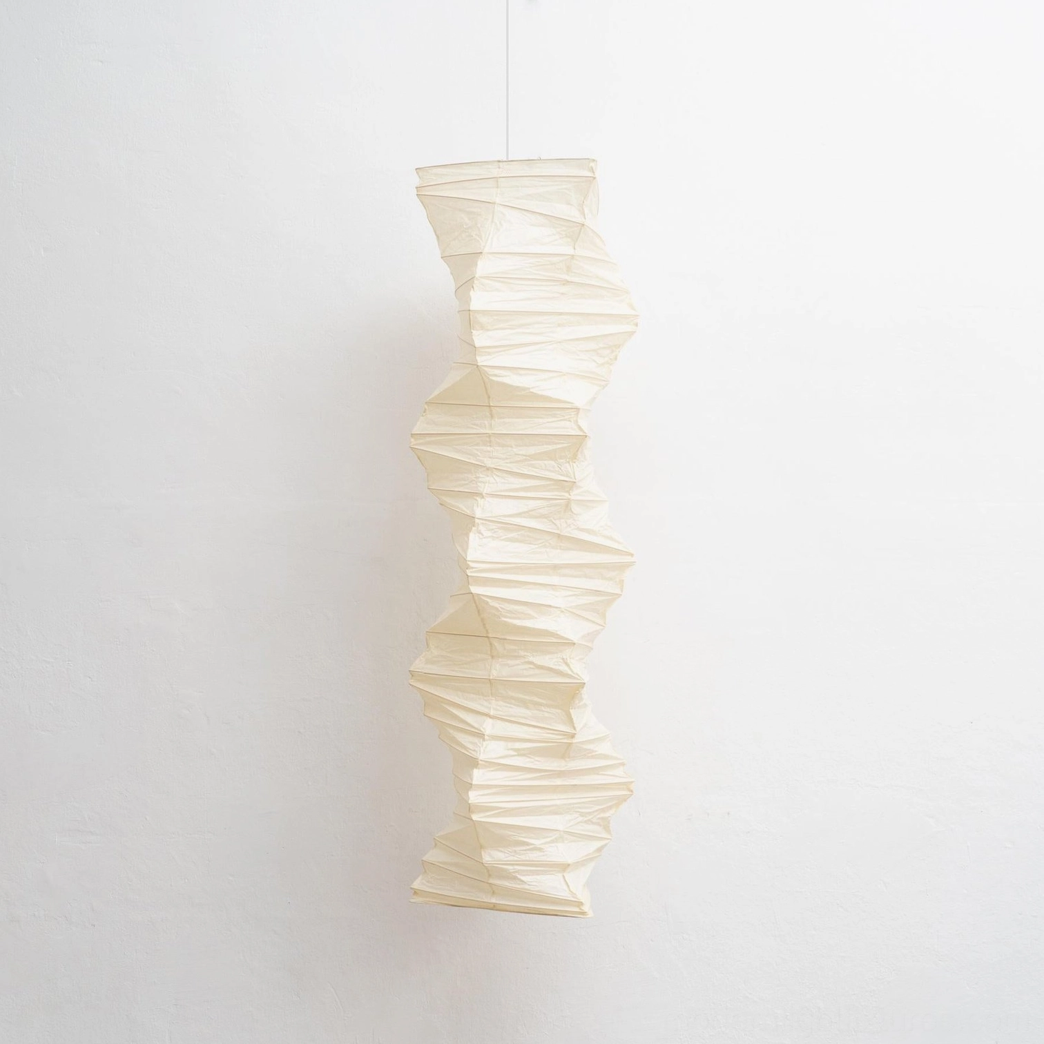Akari 33N folded paper pendant light studio photography showing fine paper texture and quality construction