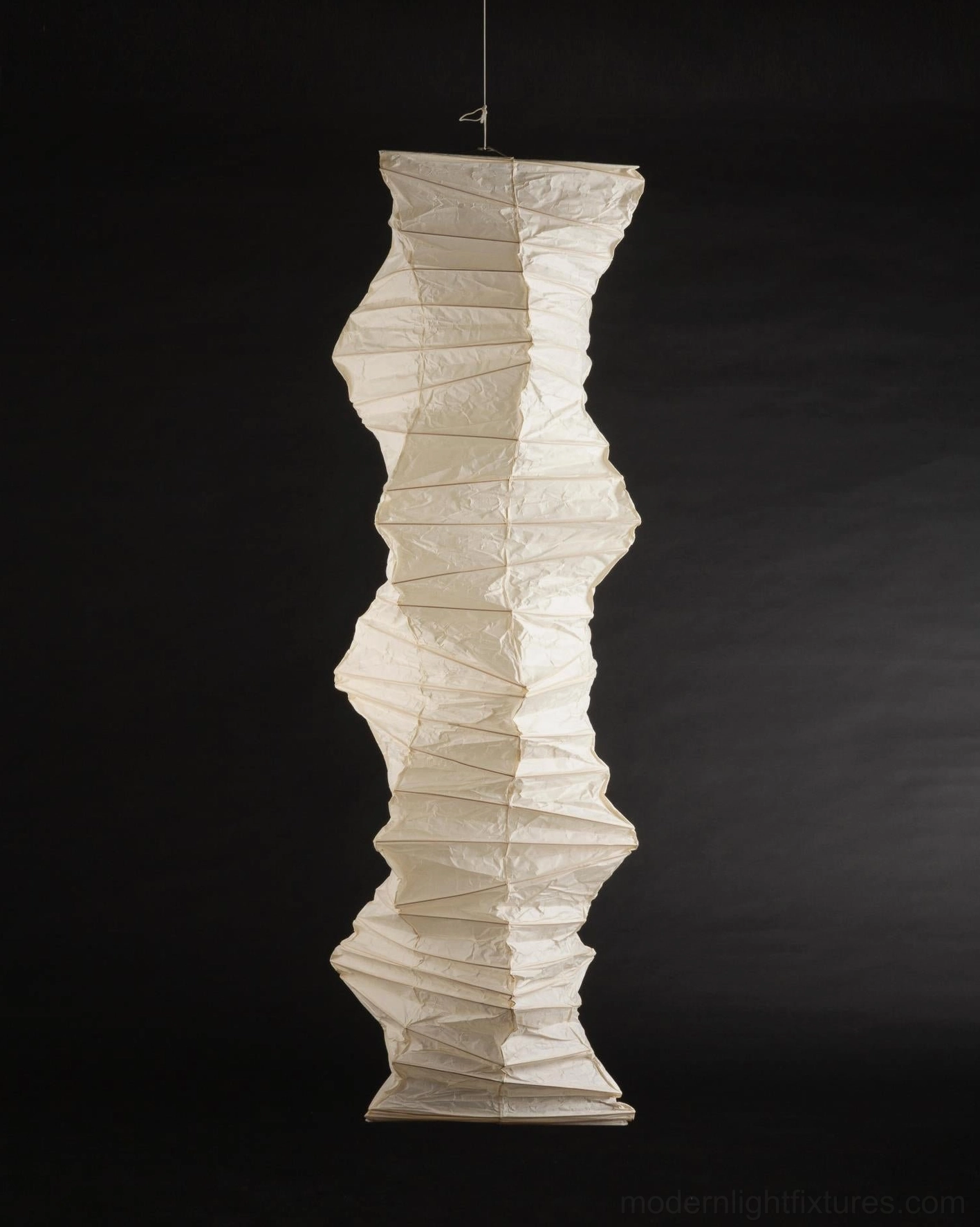 Akari 33N pendant lamp detail shot of sharp vertical folded ridges in off-white paper material studio lighting