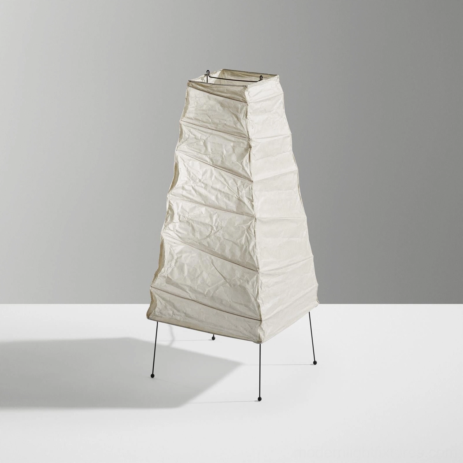Akari 4N Japanese-inspired paper table lamp with black tripod leg structure