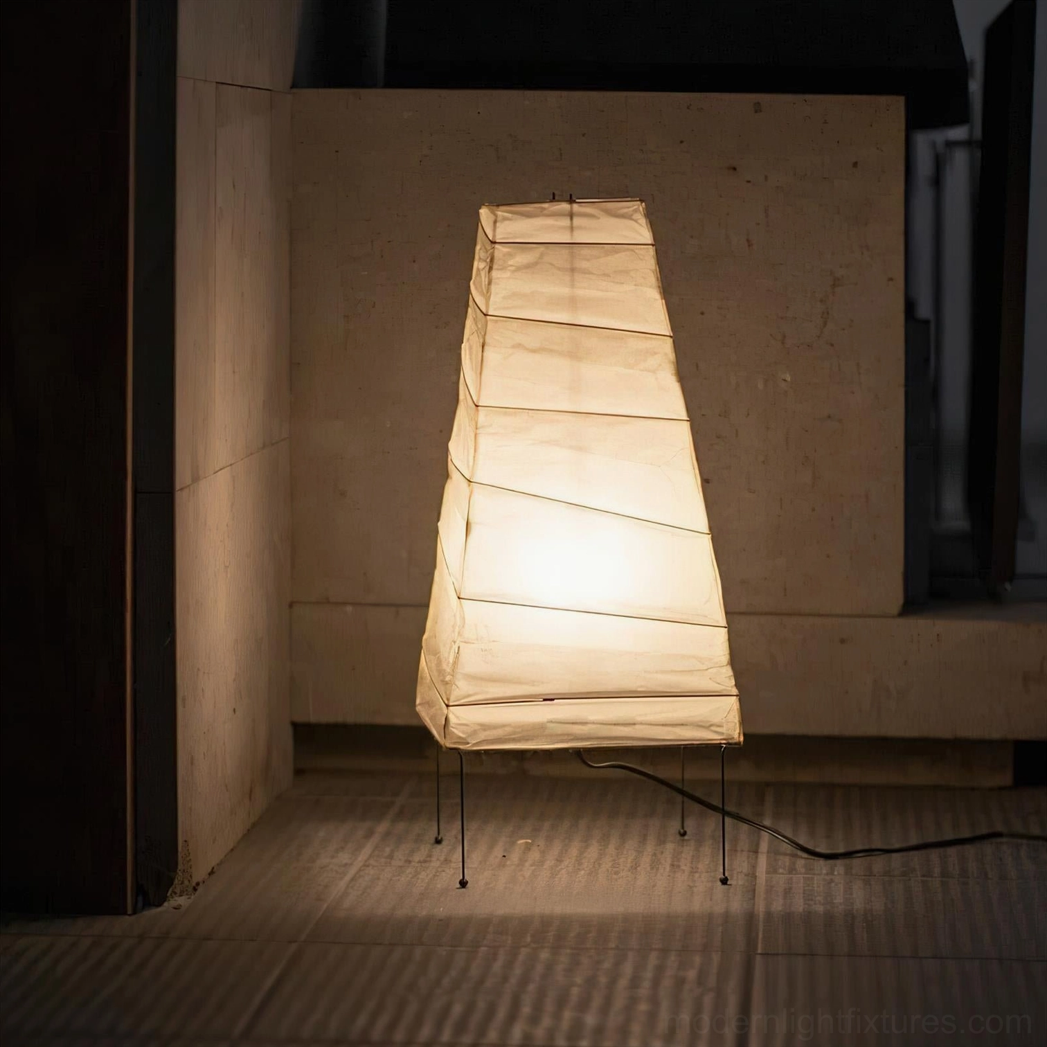Akari 4N glowing table lamp in indoor corridor creating warm ambient light