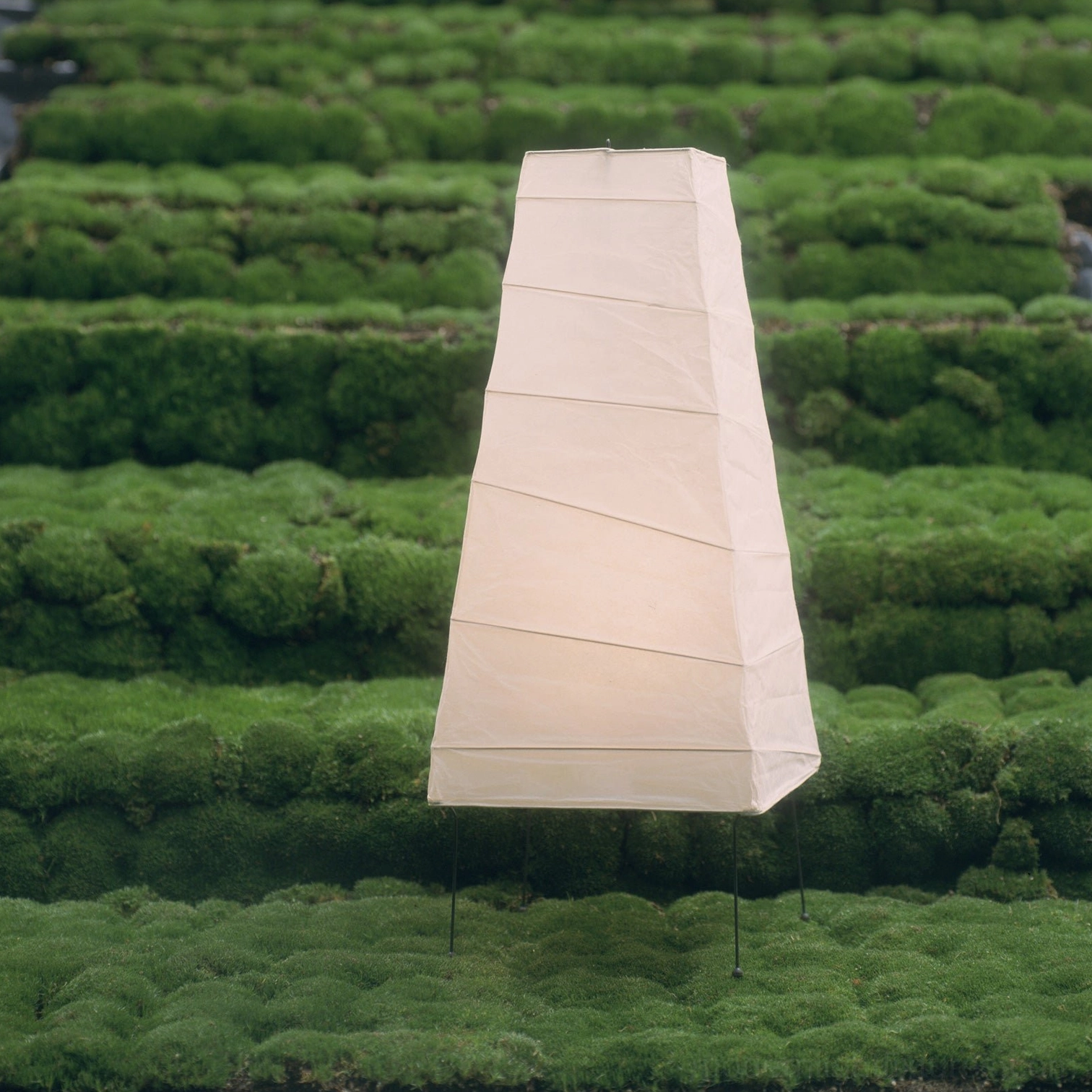 Akari 4N minimalist paper table lamp in natural outdoor garden environment