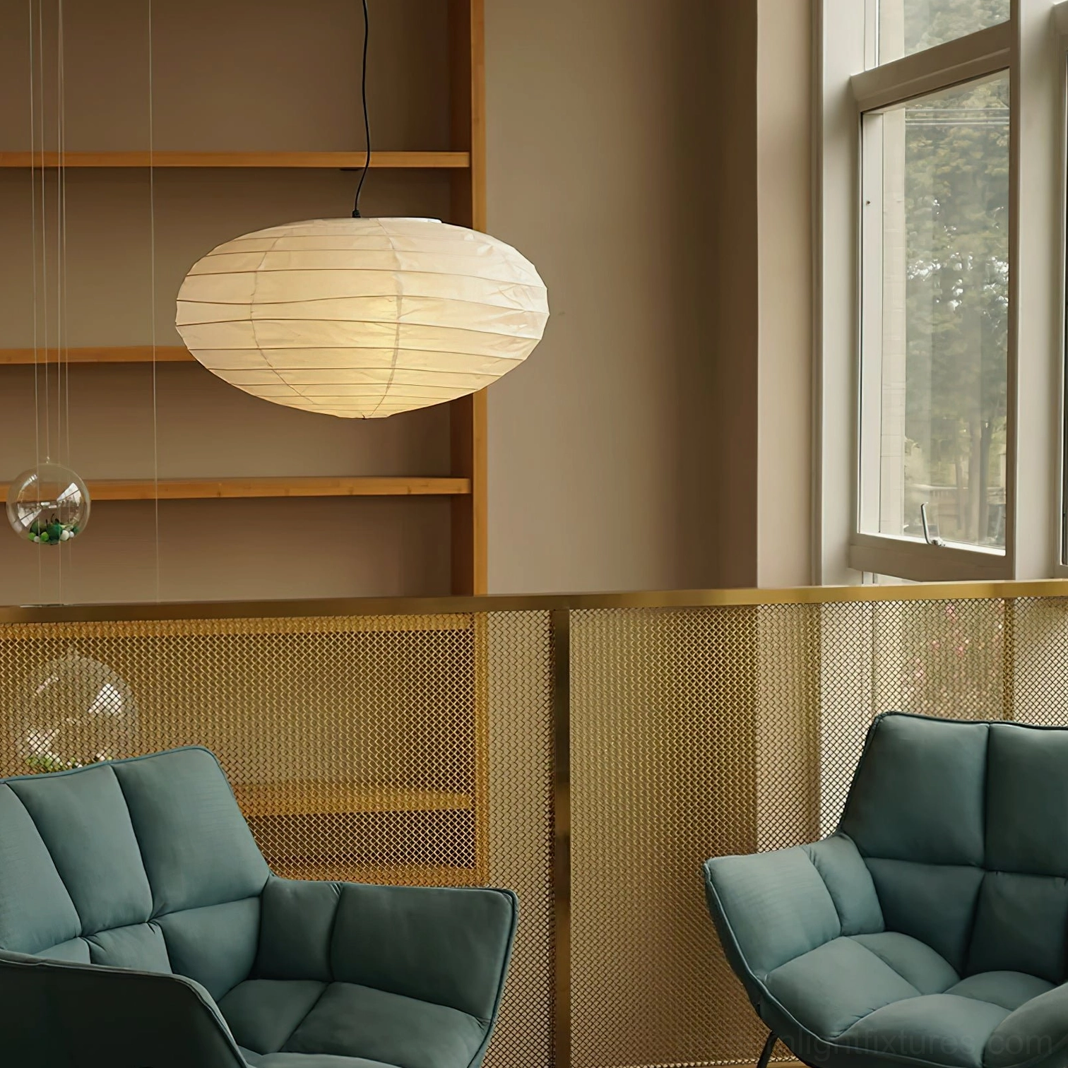 Akari 50EN hanging pendant light with black suspension cord in modern home lounge setting, creating warm ambient glow