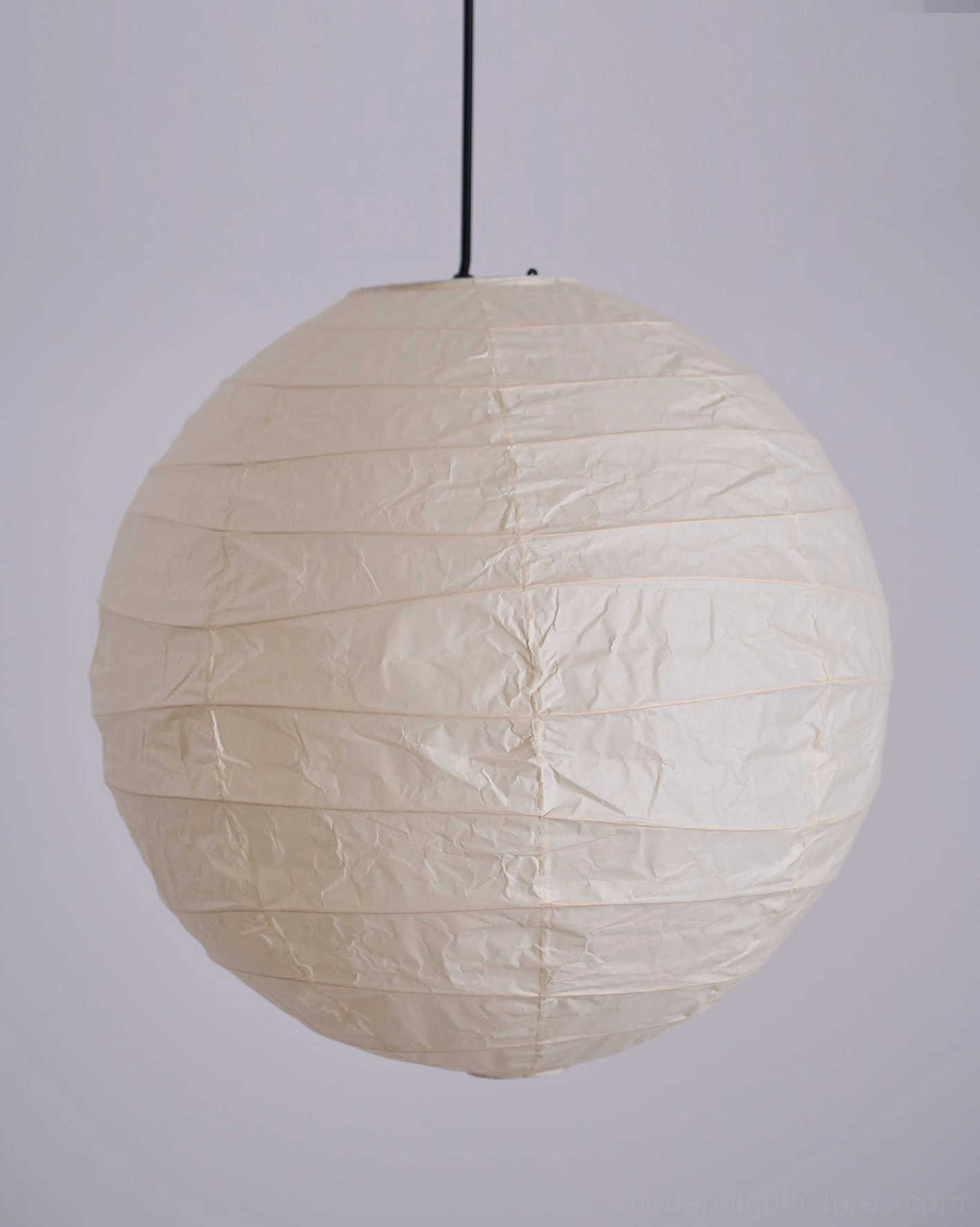Modern Japanese Washi paper pendant lamp - corner installation in minimalist living space