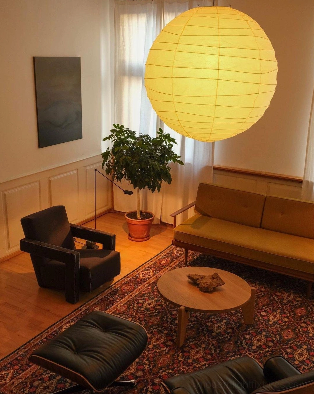Akari D Japanese Washi paper pendant lamp - three-quarter view in furnished mid-century living room with plant decor