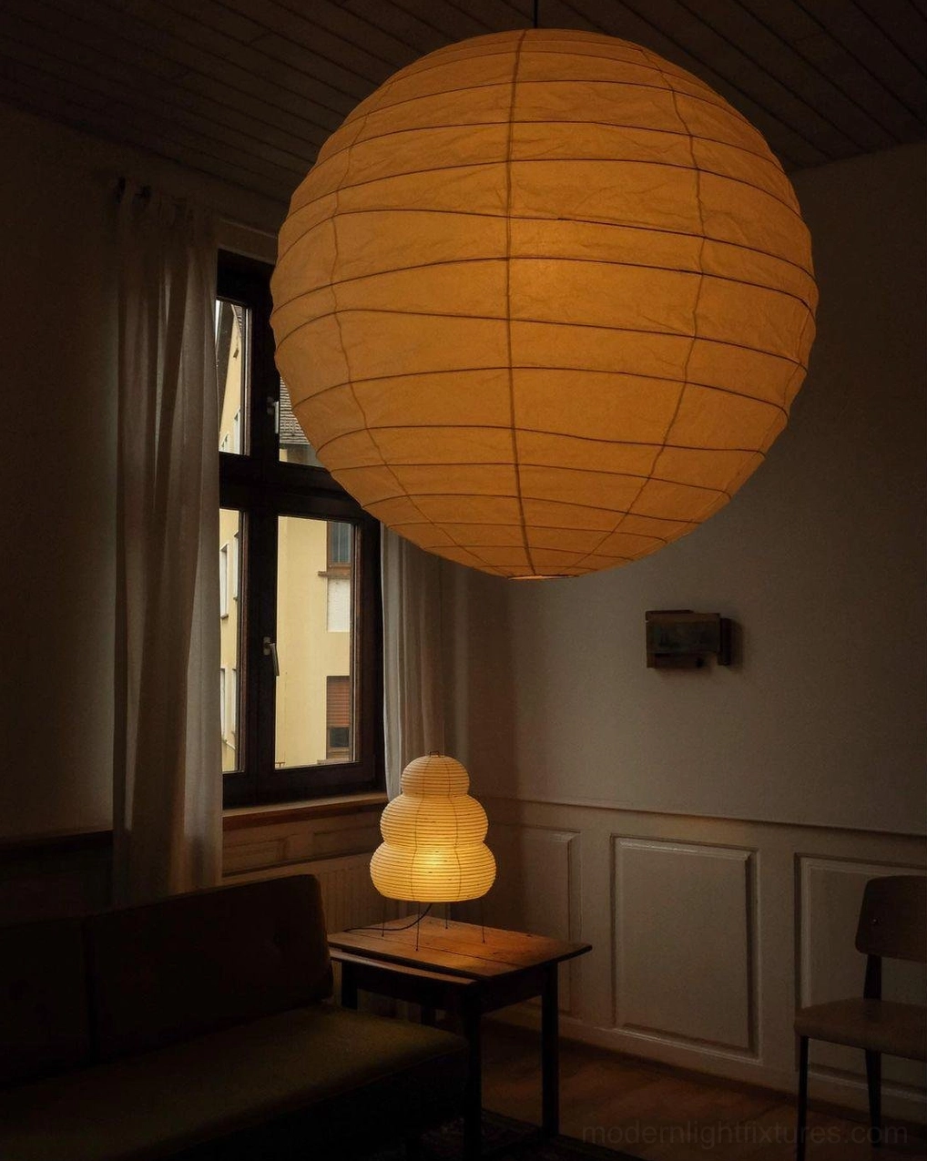 Vintage Japanese Washi pendant lamp with amber yellow glow - mounted in cozy retro lounge with wood trim