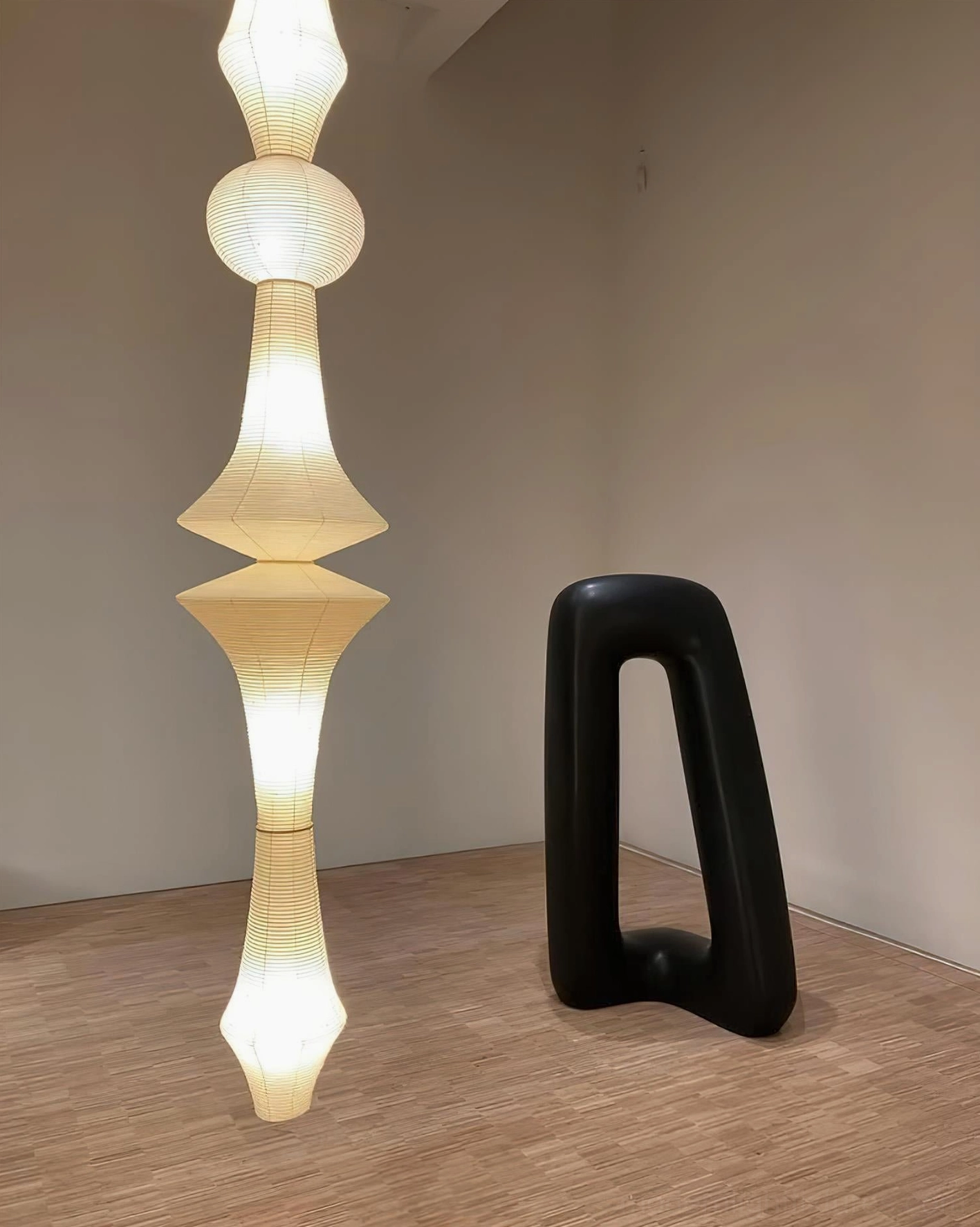 Akari E white paper pendant lamp creating warm ambient illumination in contemporary bedroom