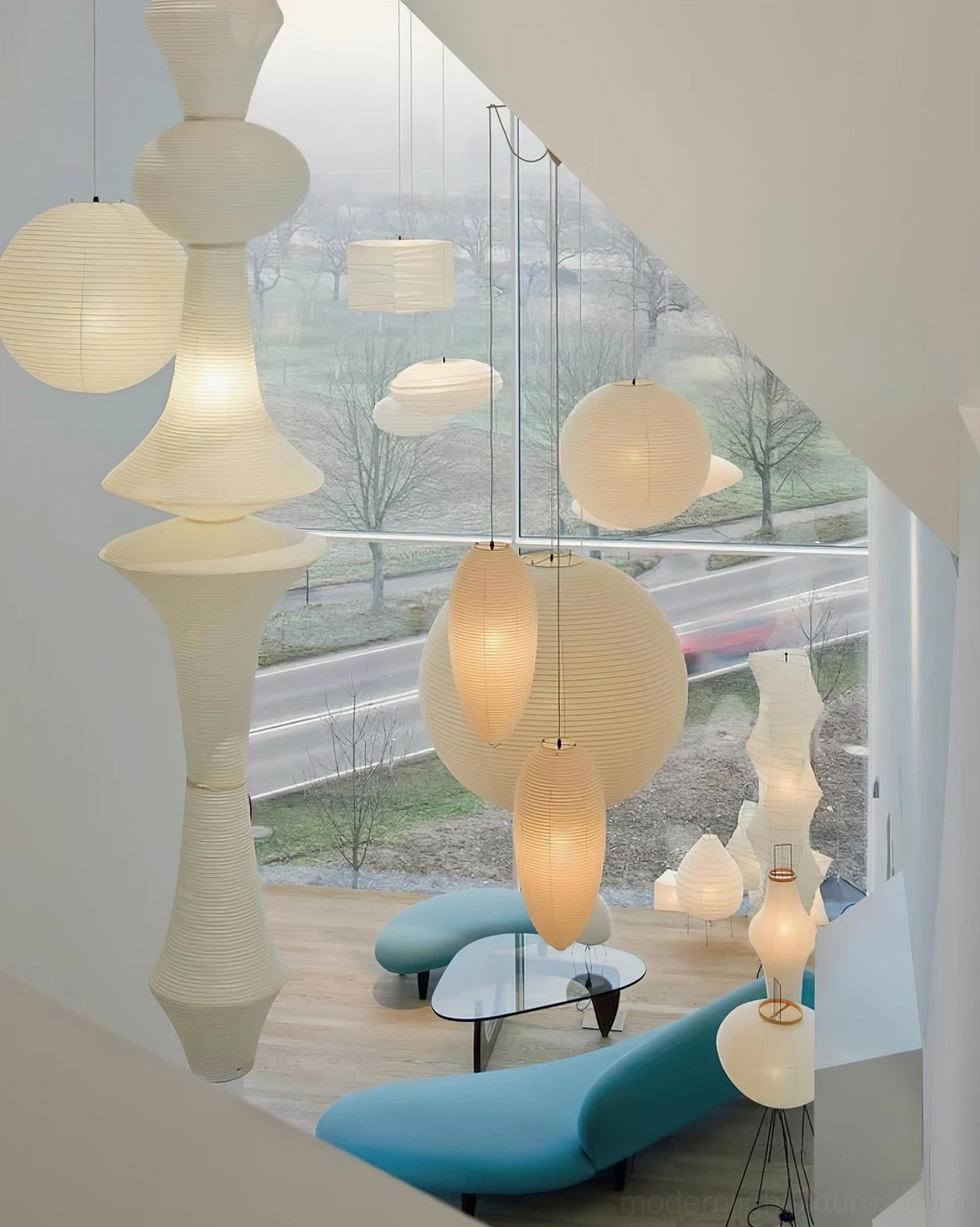 Multiple Akari E white paper pendant lamps in cluster arrangement, contemporary dining installation