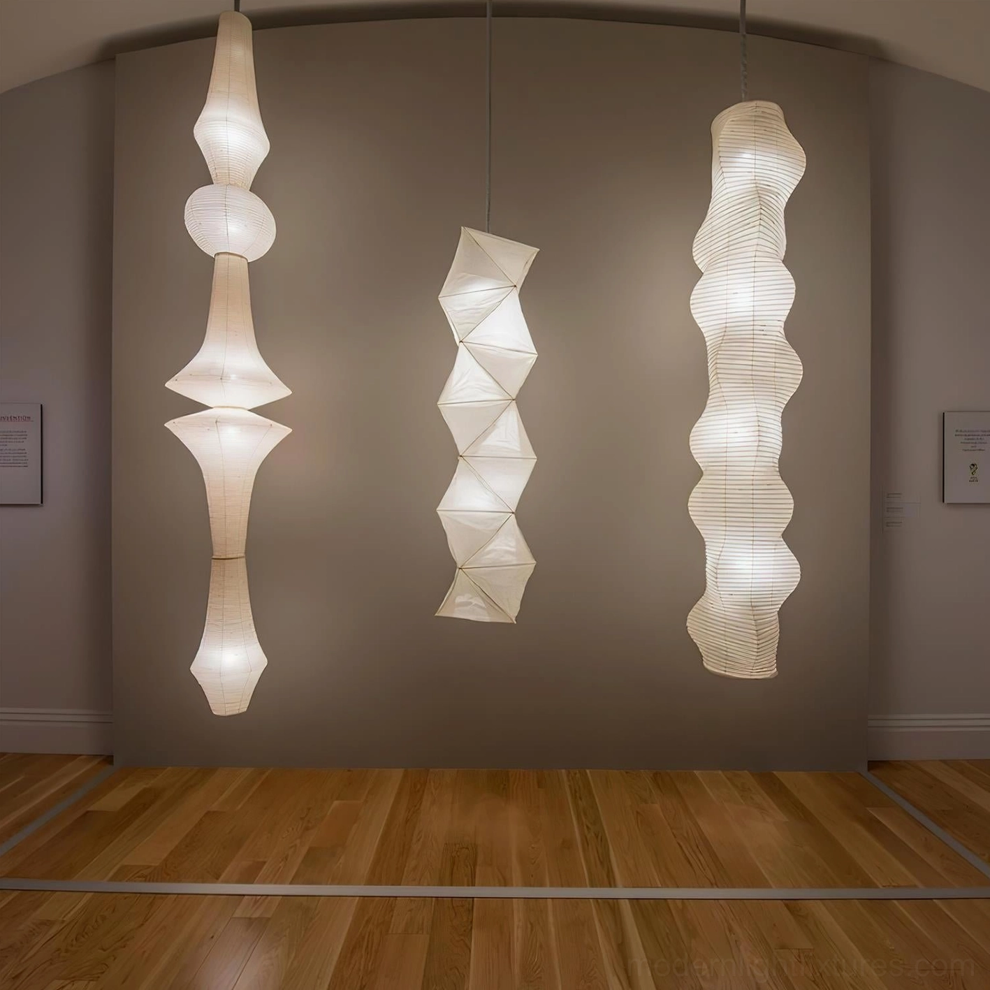 Modern white Akari E pendant lamp hanging in minimalist living room with wood flooring and warm ambient lighting