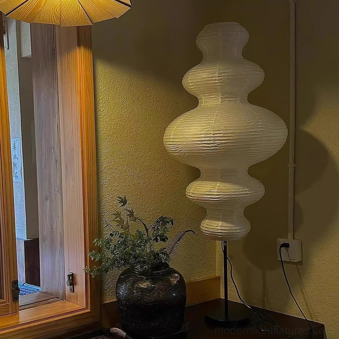 Akari Juni floor lamp in minimalist living space demonstrating artistic lighting and design presence