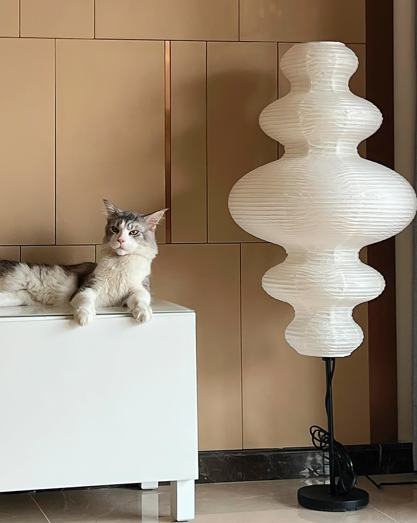 Side angle view of Akari Juni lamp in luxury residential space with warm ambient lighting